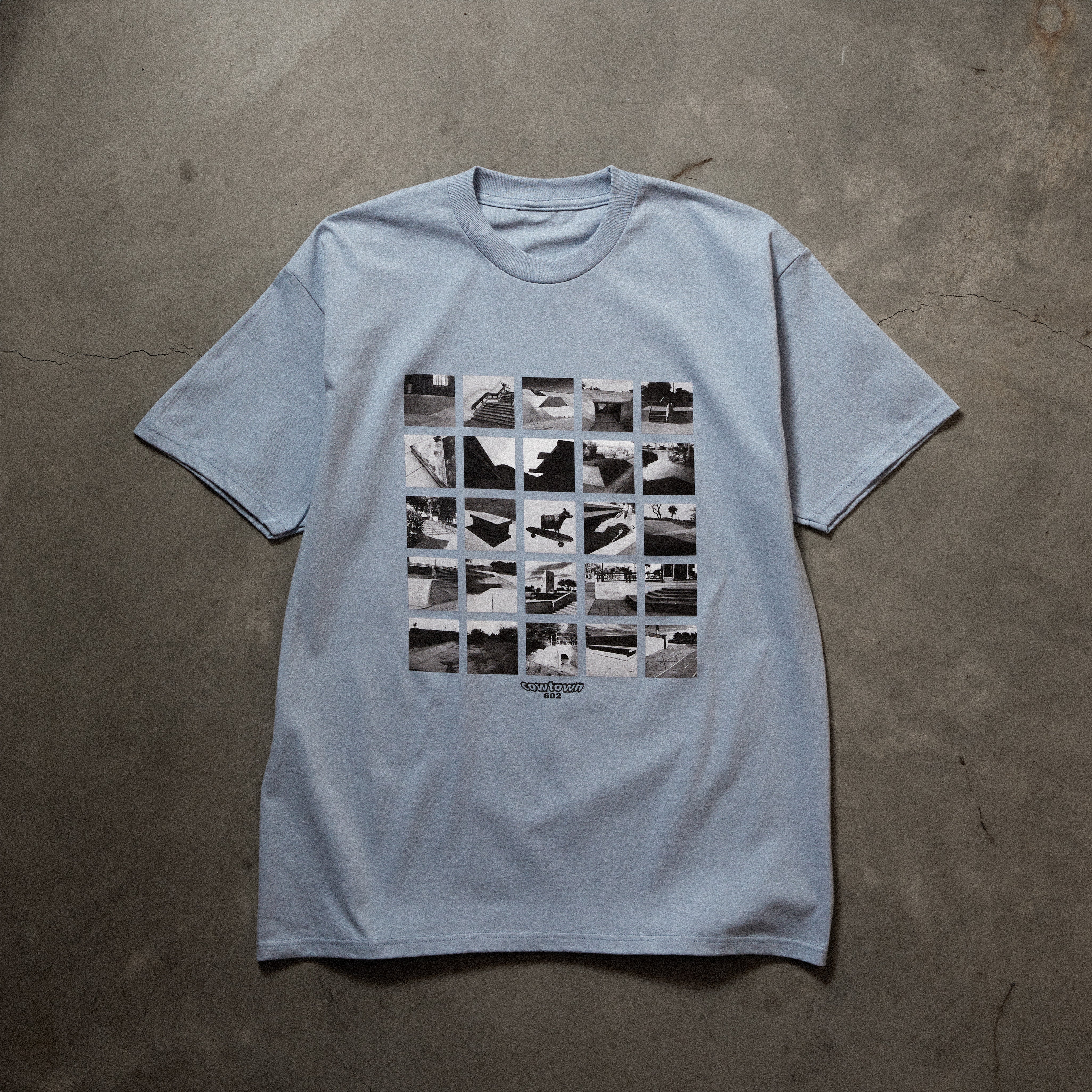 Full front image of light blue tee with printed photo collage art on chest.