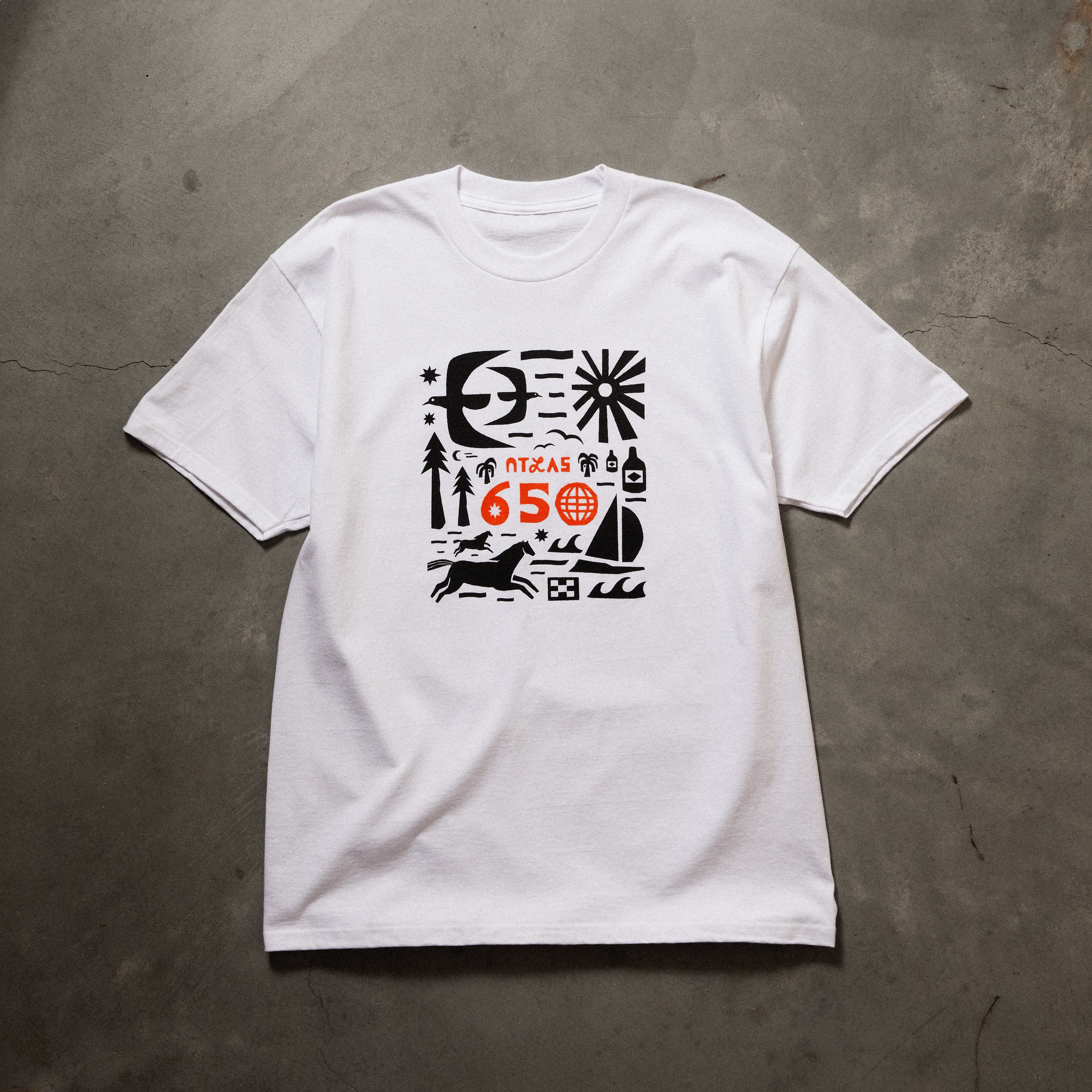 Full front image of white tee with black/orange printed art on chest