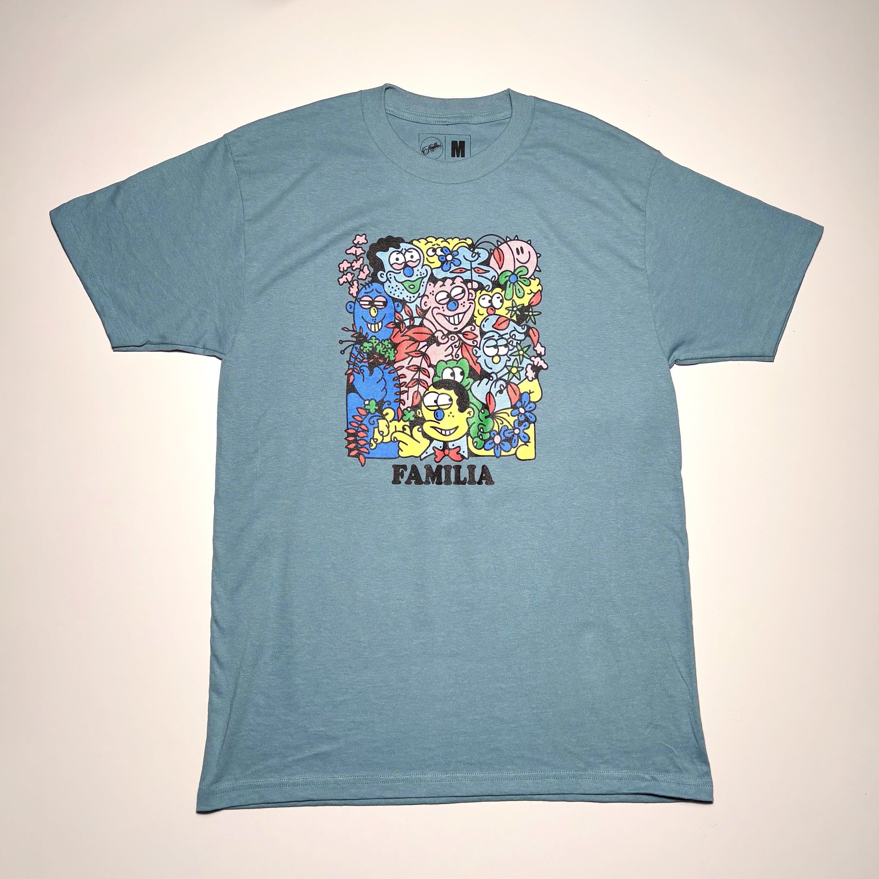 Full image of blue tee. Collage art printed on chest.