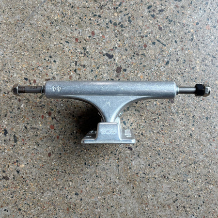 Silver skateboard truck on a concrete surface