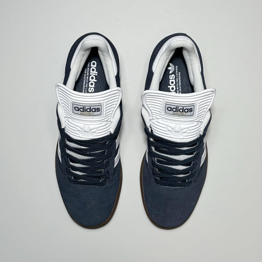 A pair of Adidas Skateboarding Busenitz Pro low-top sneakers in navy blue and white, shown from a top-down view on a light gray background.