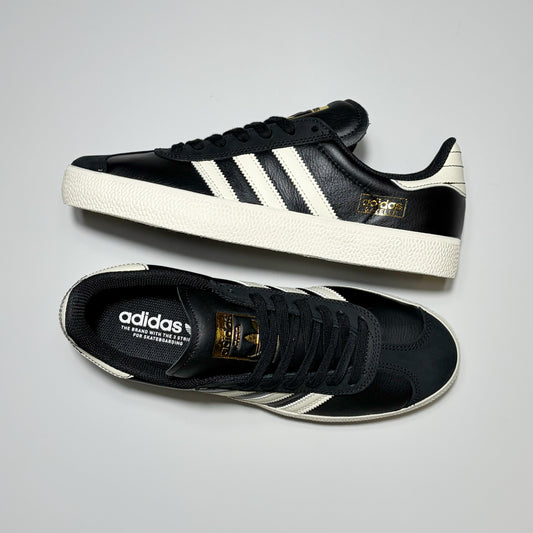 Pair of Adidas Gazelle ADV shoes on grey background.