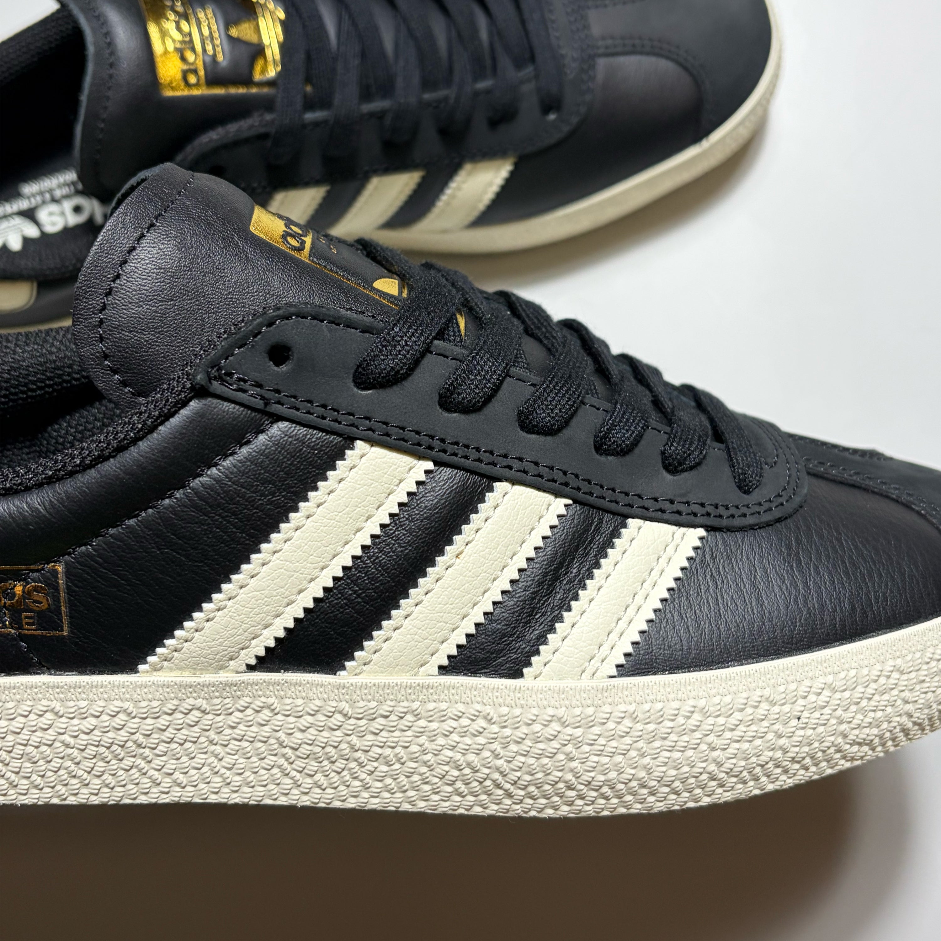 Close detail of white Adidas Stripes on black leather Gazelle ADV