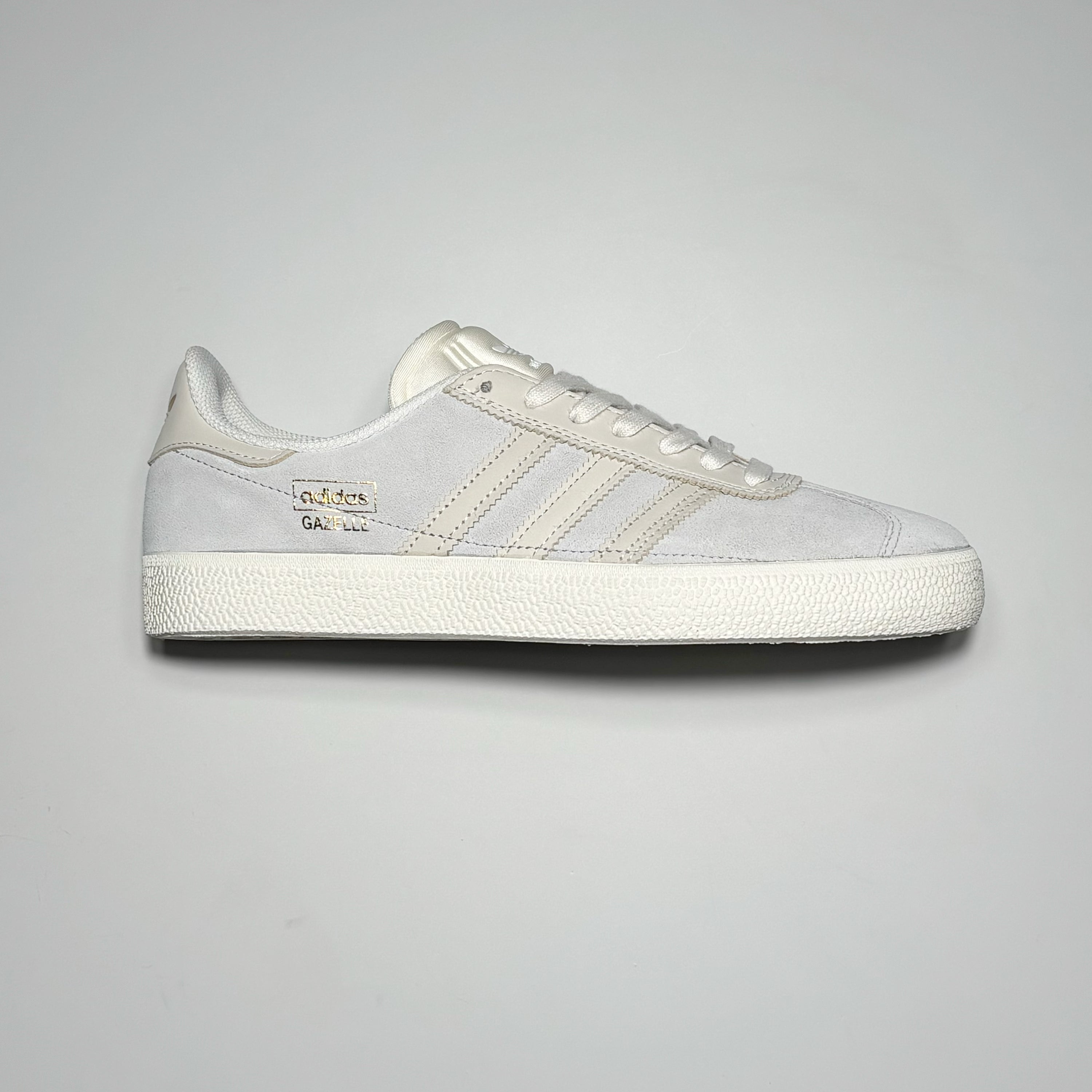 Side image of right shoe. Chalk grey suede with white stripes and midsole.