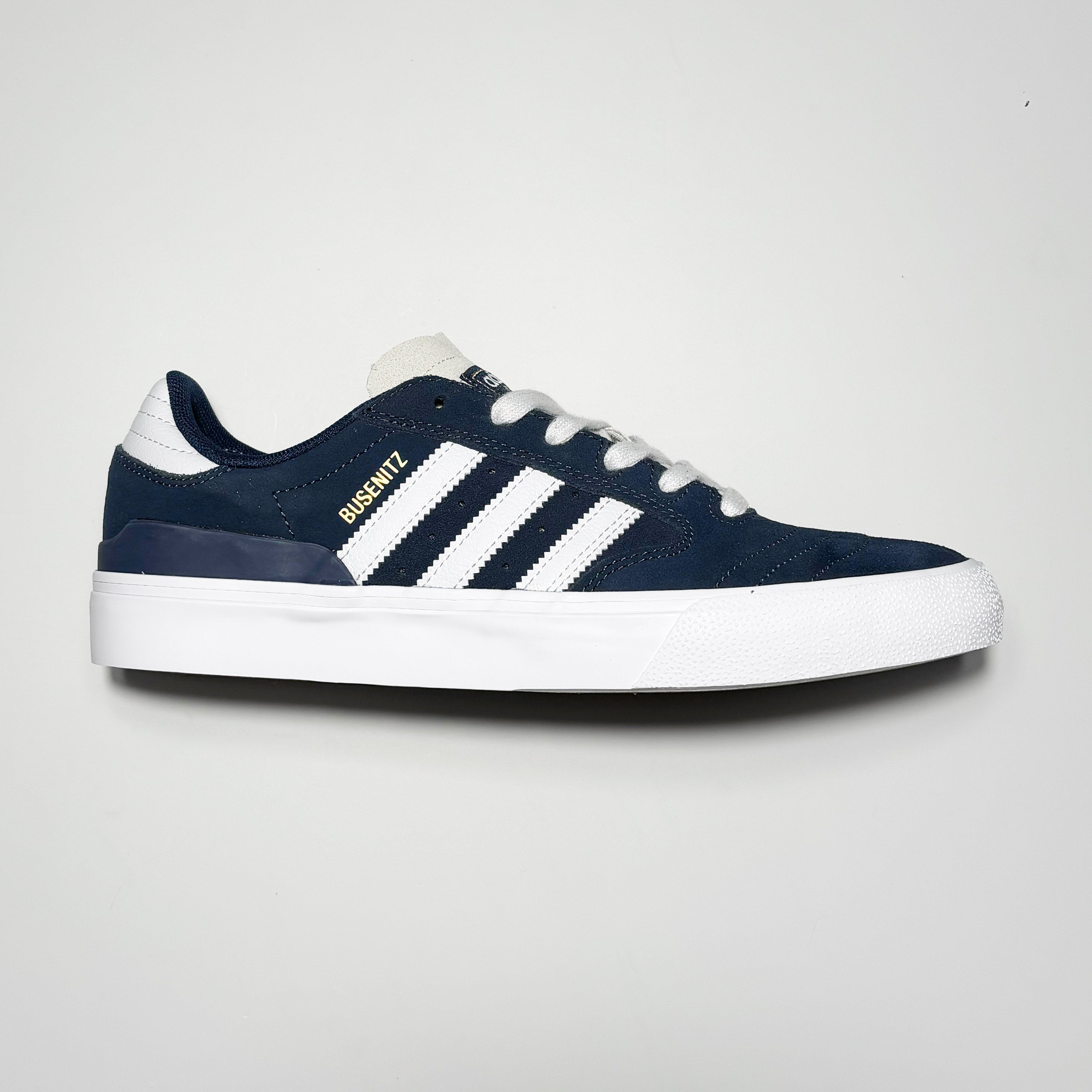 Side image of right shoe. Navy suede with white stripes.