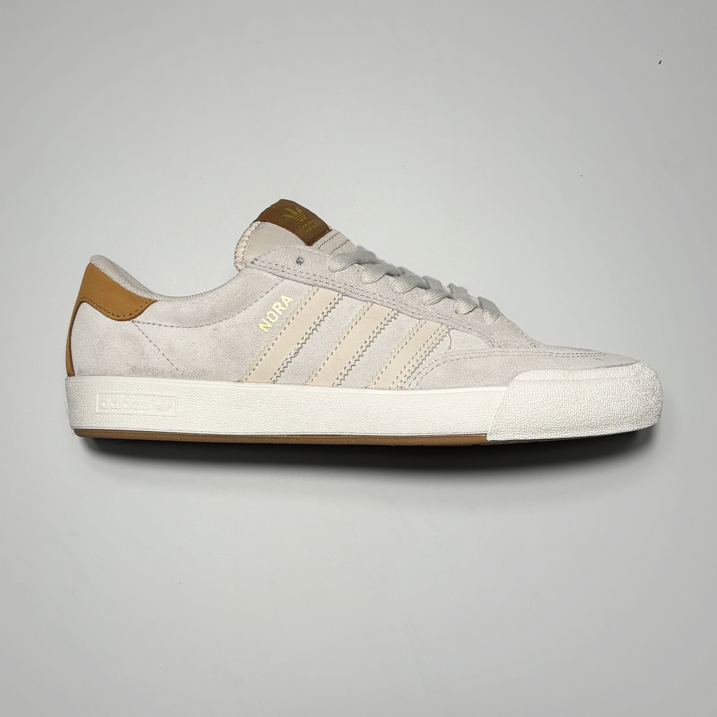 Side image of right shoe. Aluminum suede with tan heel tap and tongue branding