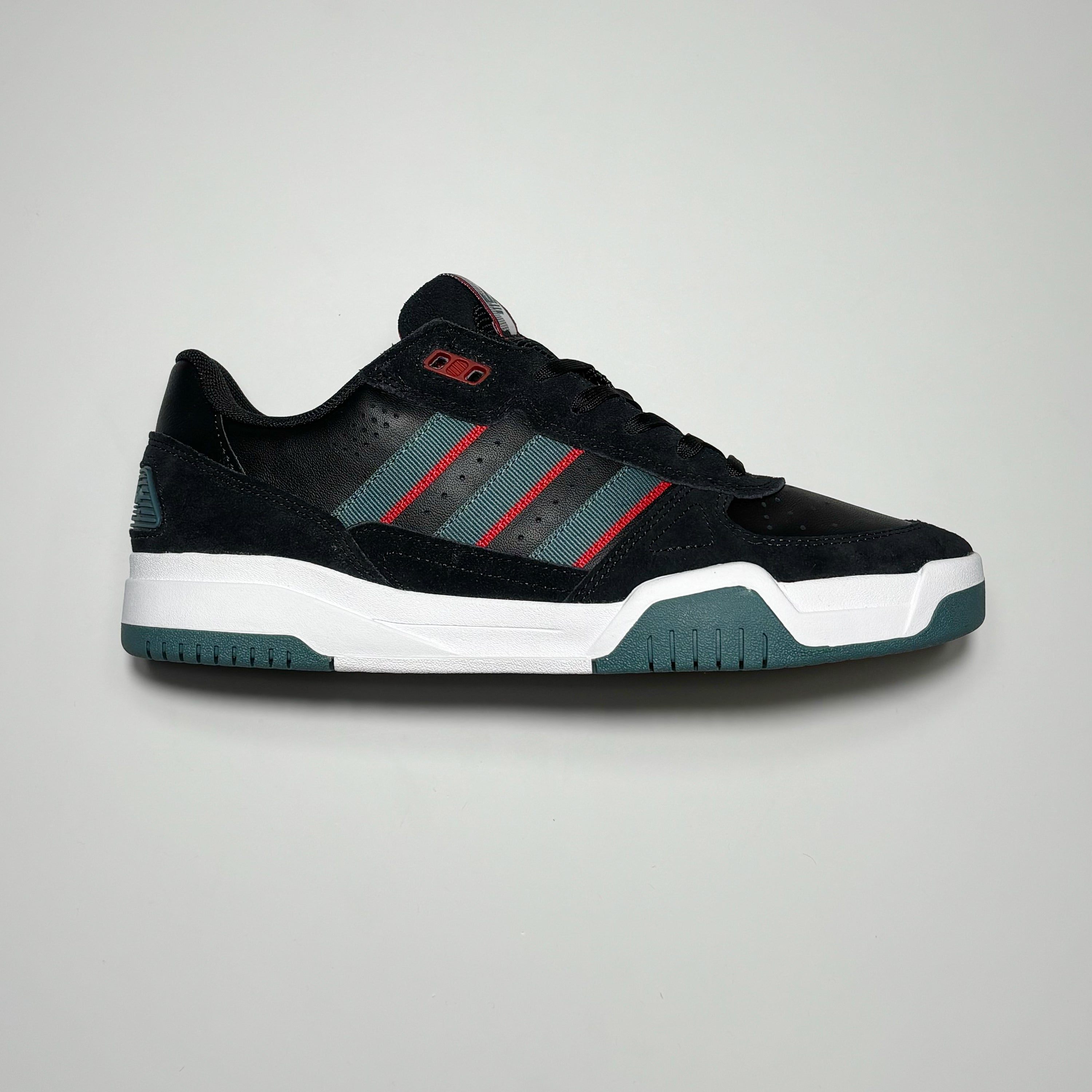 Side image of right shoe.
Black suede with teal green stripes.