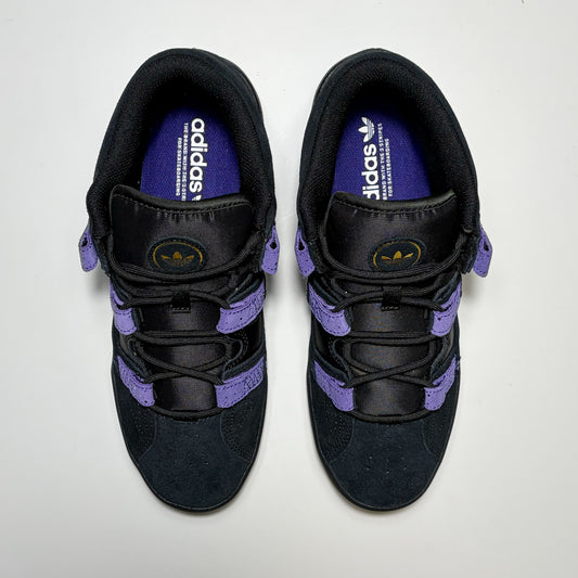 A pair of Adidas Kader sneakers shown from a top-down view. The shoes are primarily black with prominent purple accents on the laces, side straps, and inner lining, and a gold logo on the tongue.