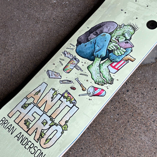 Skateboard deck with a colorful graphic and 'Antihero' text on a textured surface