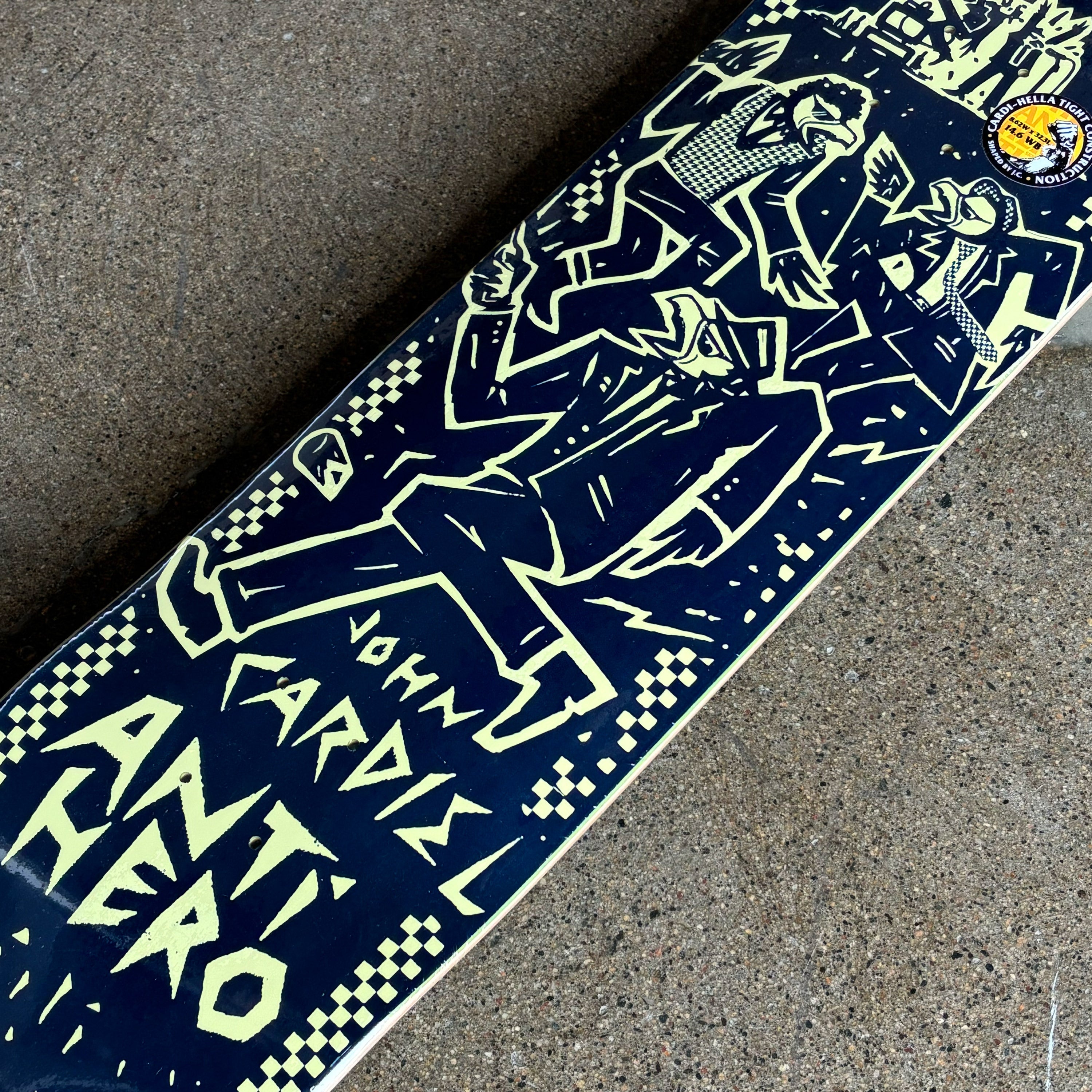 Skateboard deck with graphic design and text on a concrete surface