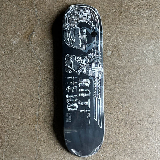 Black skateboard deck with detailed design on a concrete surface