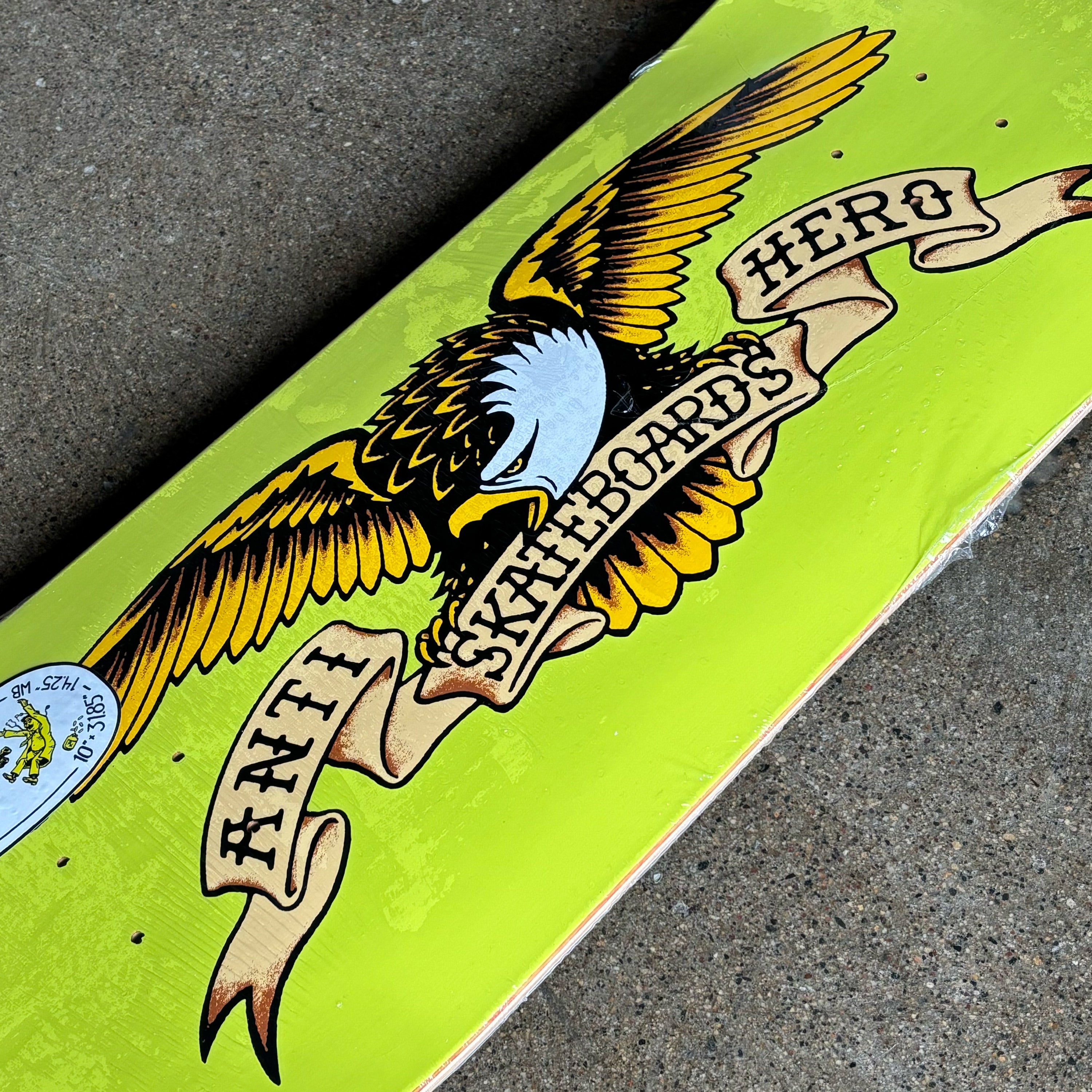 Skateboard deck with eagle design and text on a green background