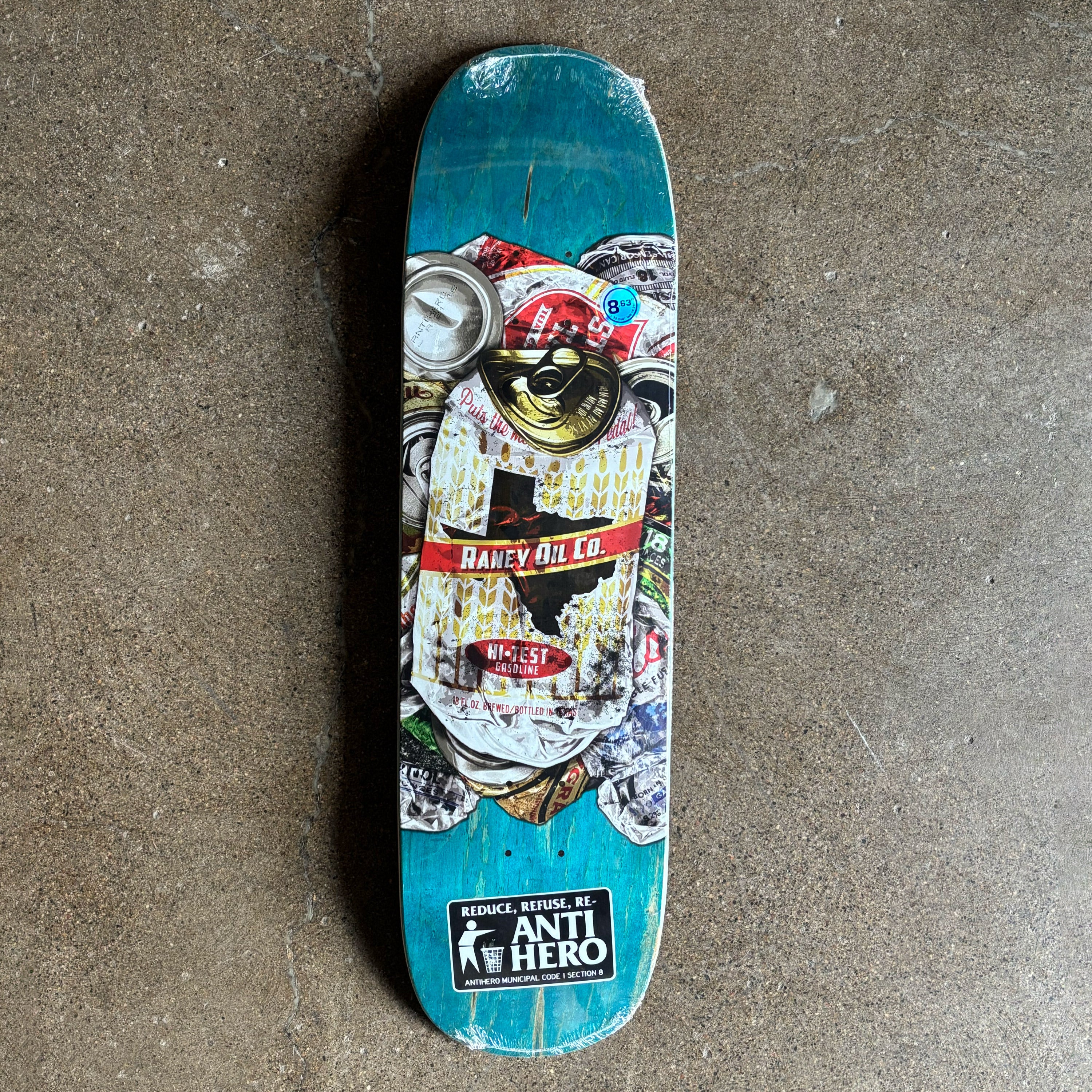 Skateboard deck with colorful graphics and brand logos on a concrete surface