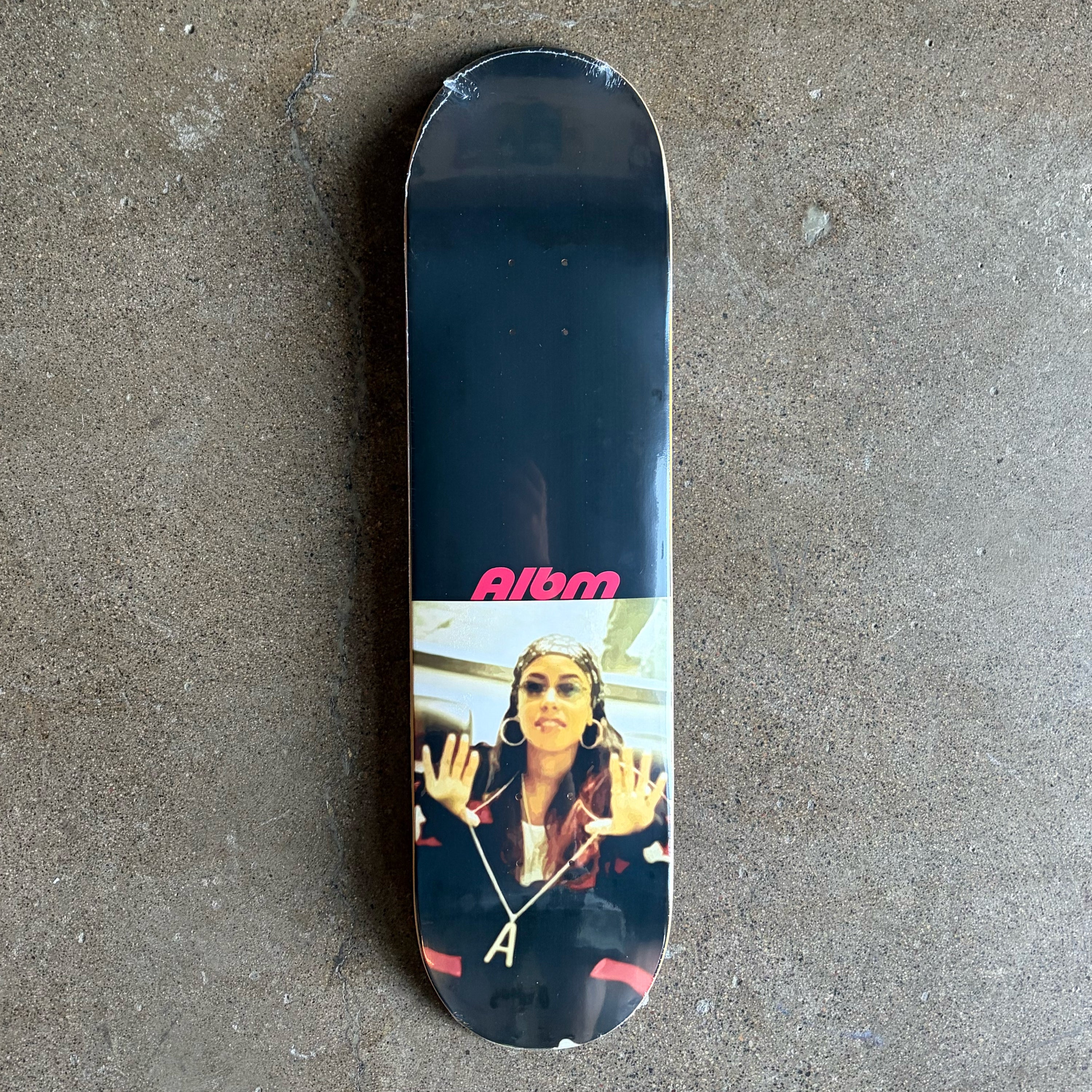 Full image of Album Skateboard deck with photo of Aaliyah and ALBM text in red.