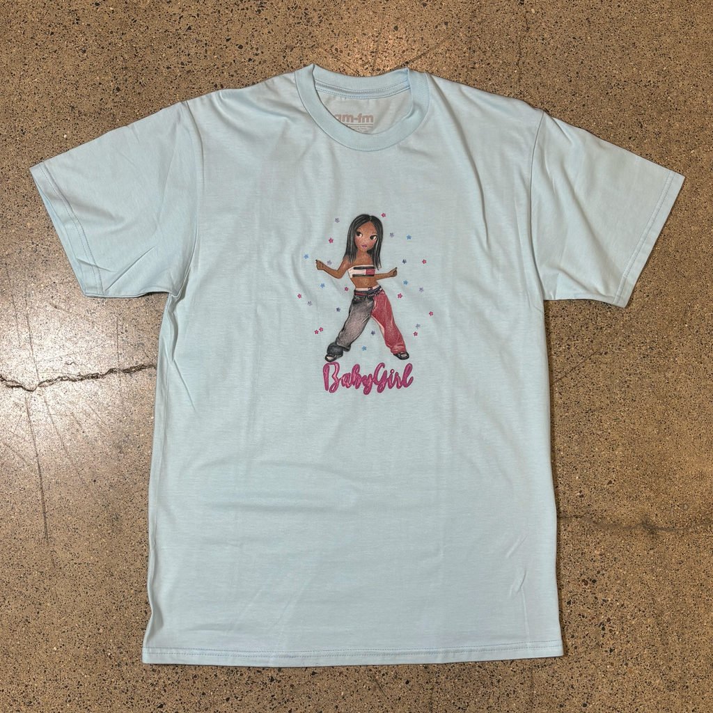 FONT SIDE OF A LIGHT BLUE T-SHIRT, CENTER GRAPHIC OF CARTOON DRAWING OF AALIYAH WITH FONT THAT READS 