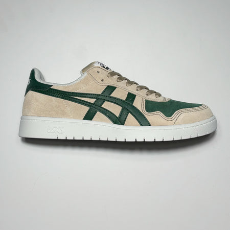 Image of right shoe. 
Light tan suede with green branding.