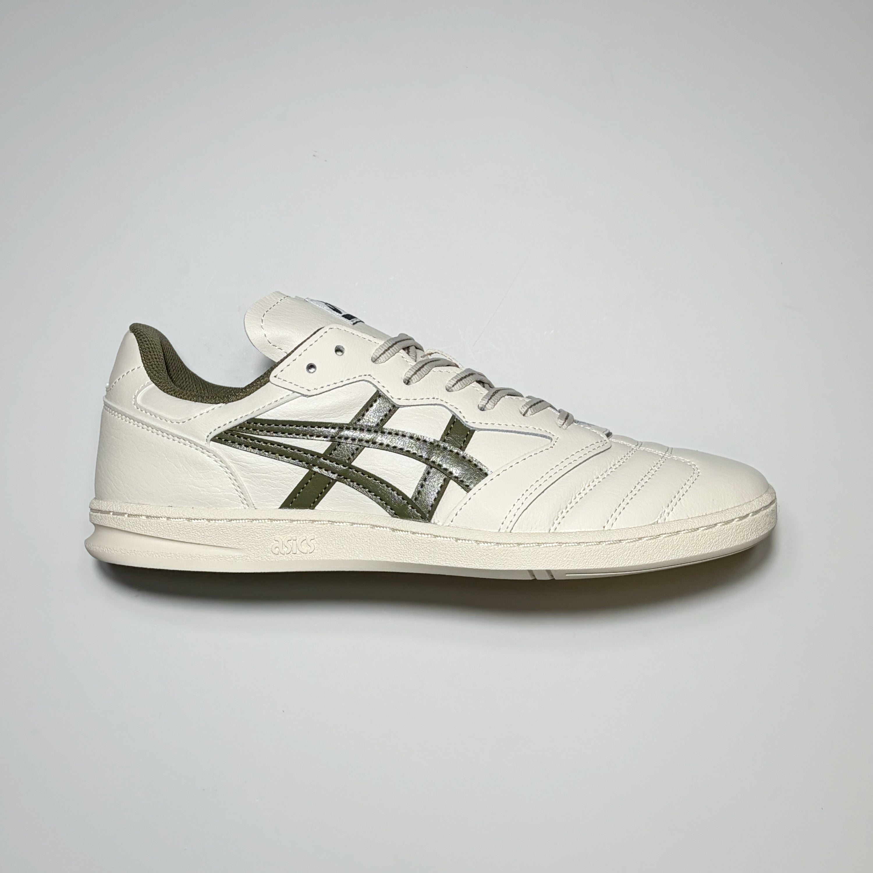 Right side image, Asics Skateboarding Leggerezza shoes. Cream leather with green branding. 