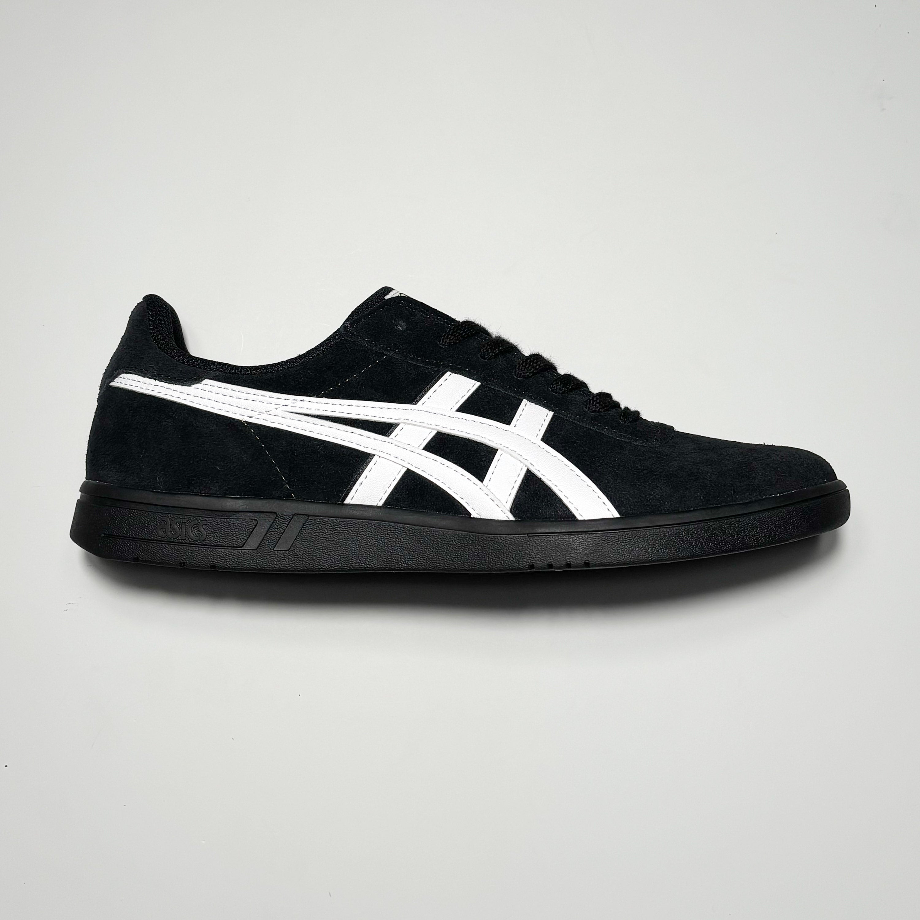 Side image of right shoe. Black suede with white asics branding and full black outsole.