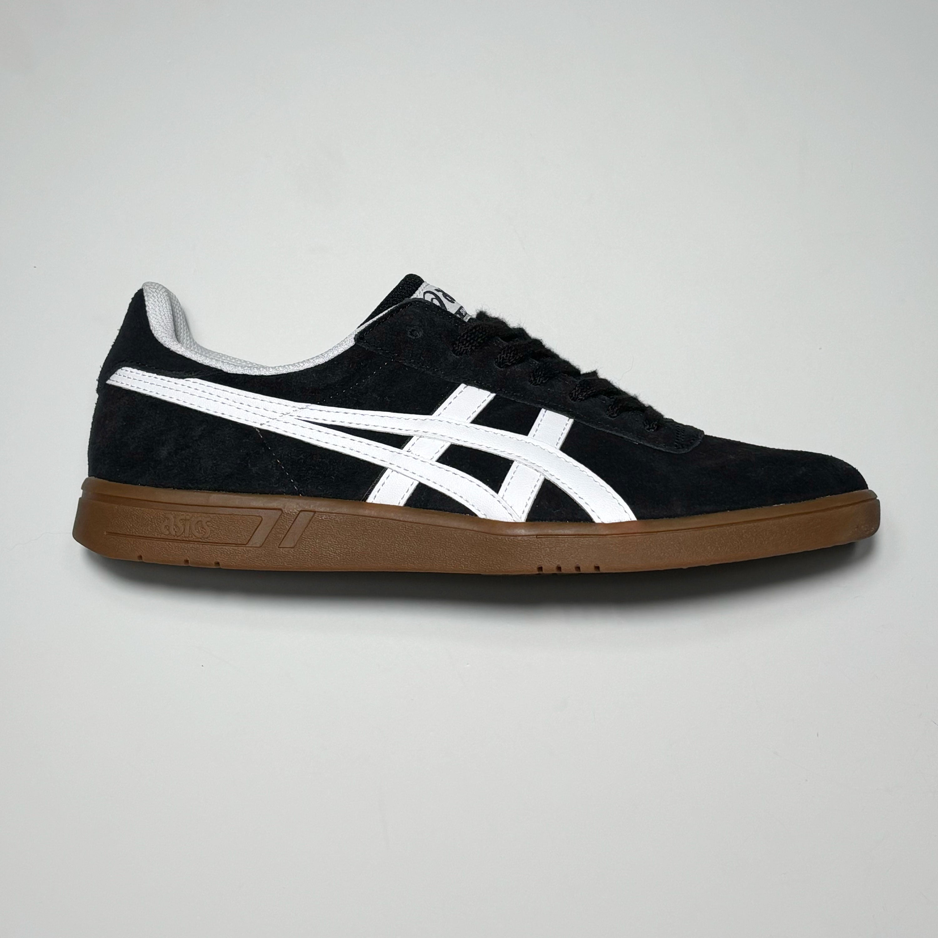 Side profile of right shoe. Black suede with gum outsole and white branding.