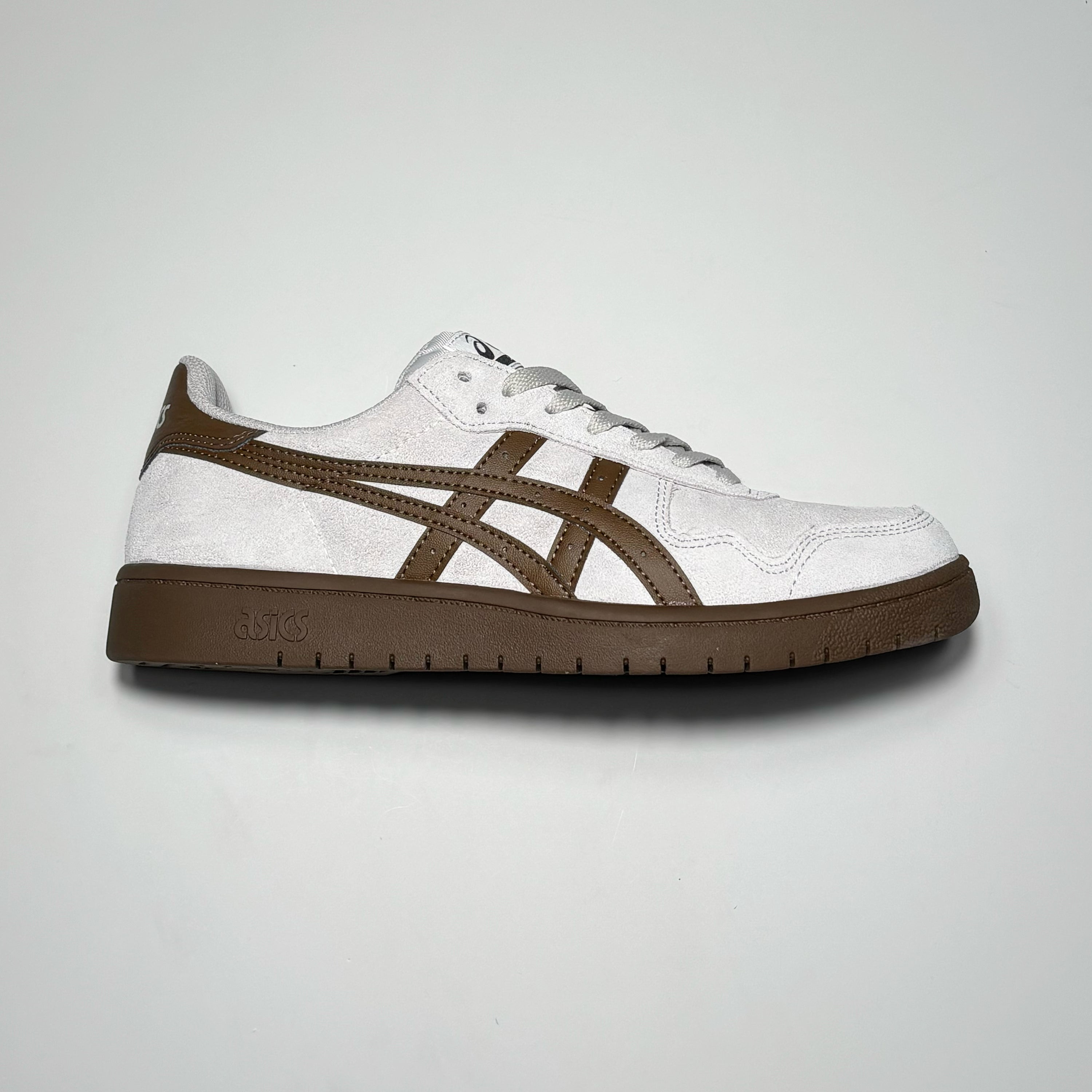 Side image of right shoe.
Cloud grey suede with tonal brown asics branding and outsole.