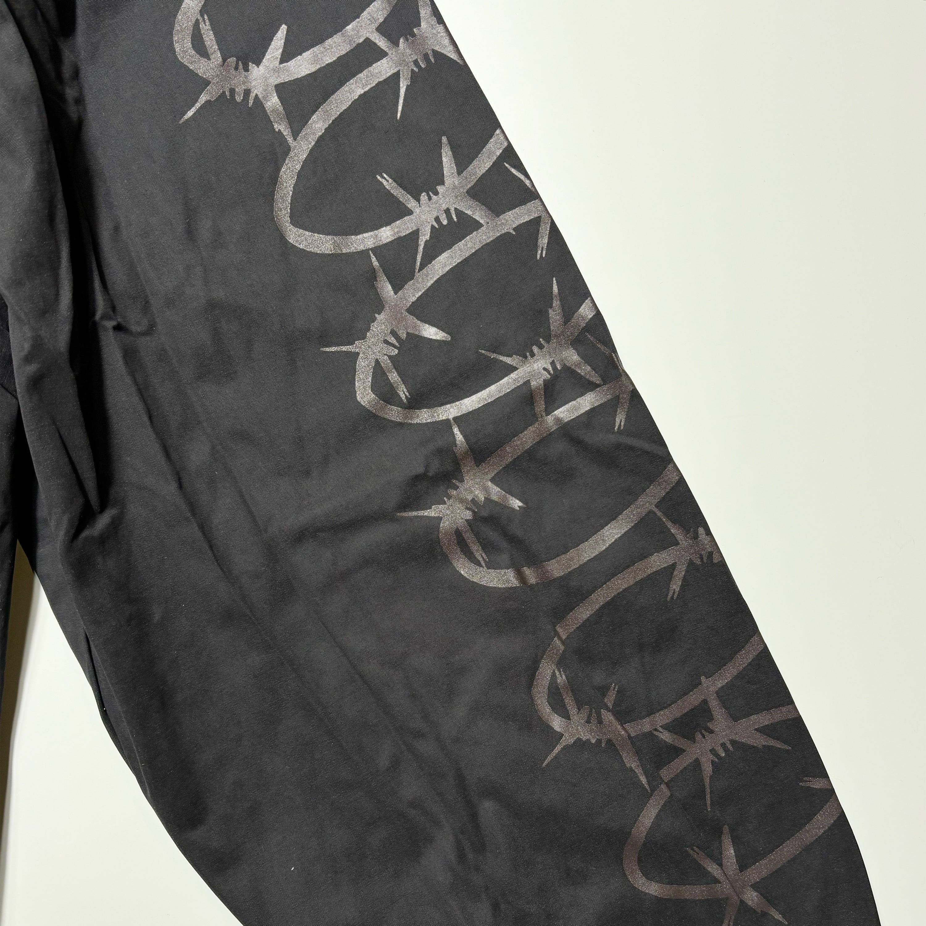 Detail of barbwire printed art down both sleeves