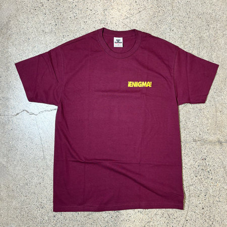 Front image of burgundy tee with yellow printed enigma font. 