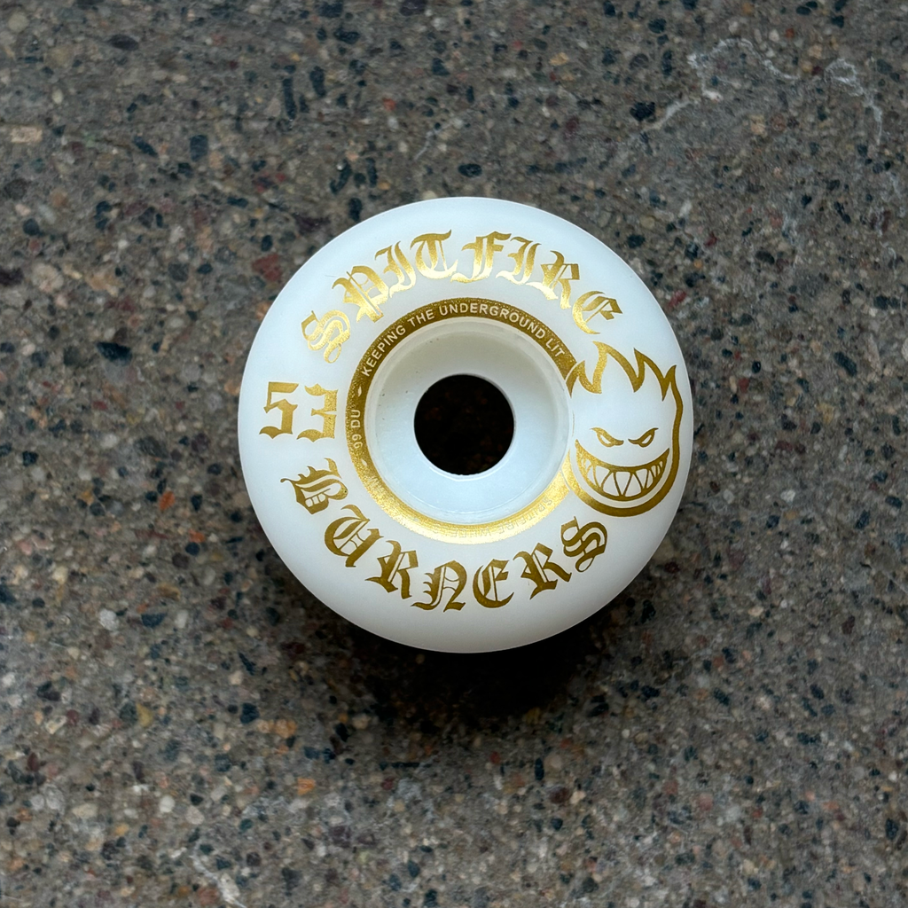 Image of white wheel with gold artwork.