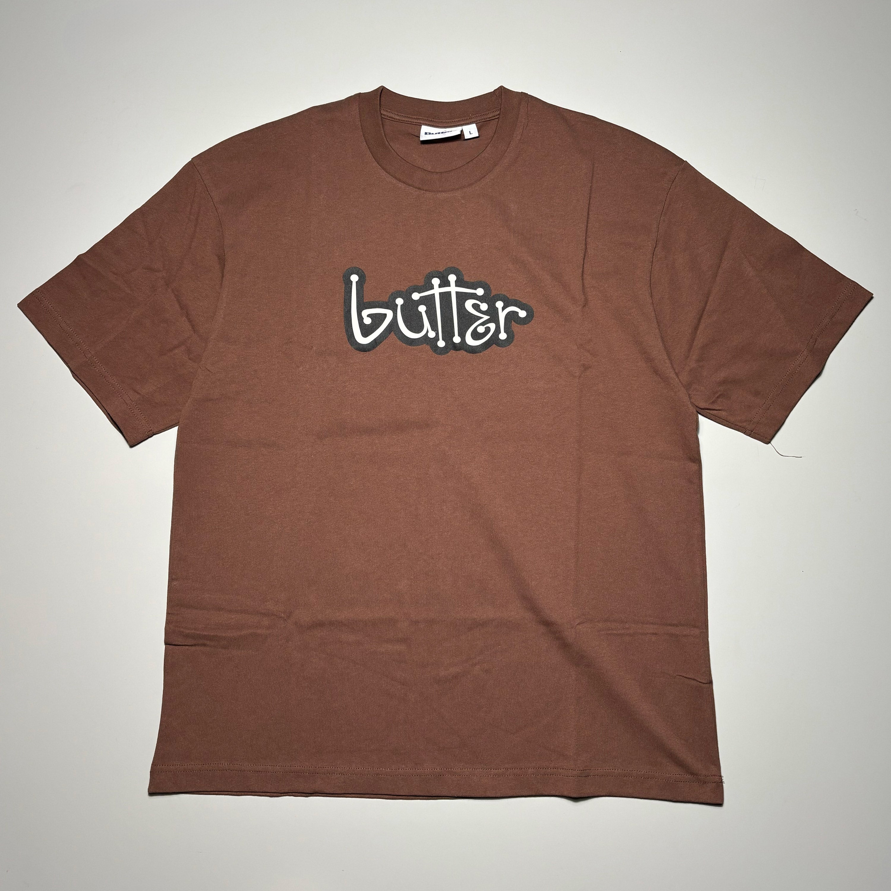 Front image of brown tee with butter logo printed on chest.