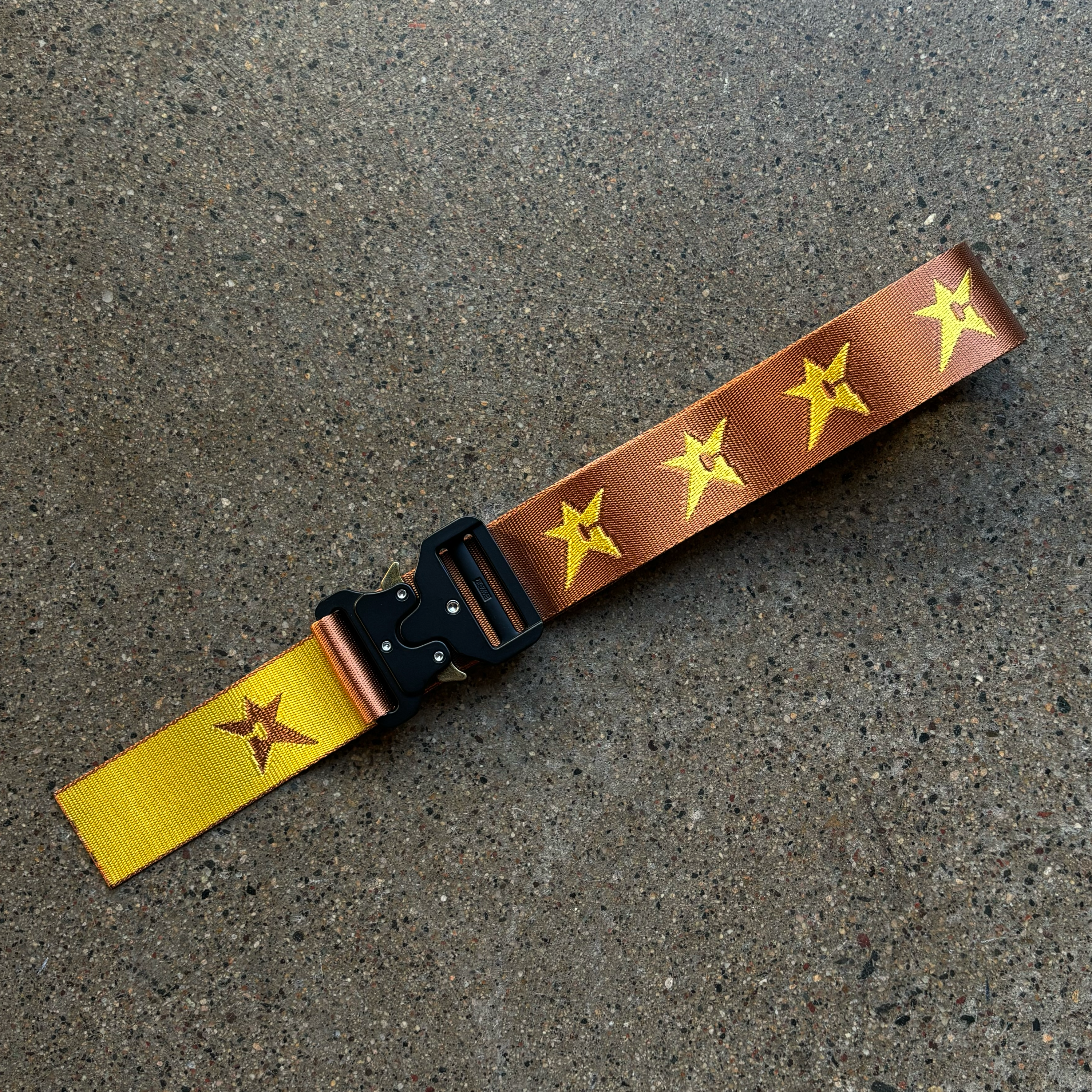 Full image of woven brown belt with yellow stars & heavy duty clasp.