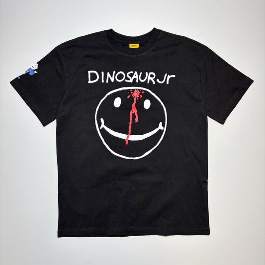 Carpet Company Dinosaur Jr Tee in black with white printed smiley face and red ink splat on forehead.
