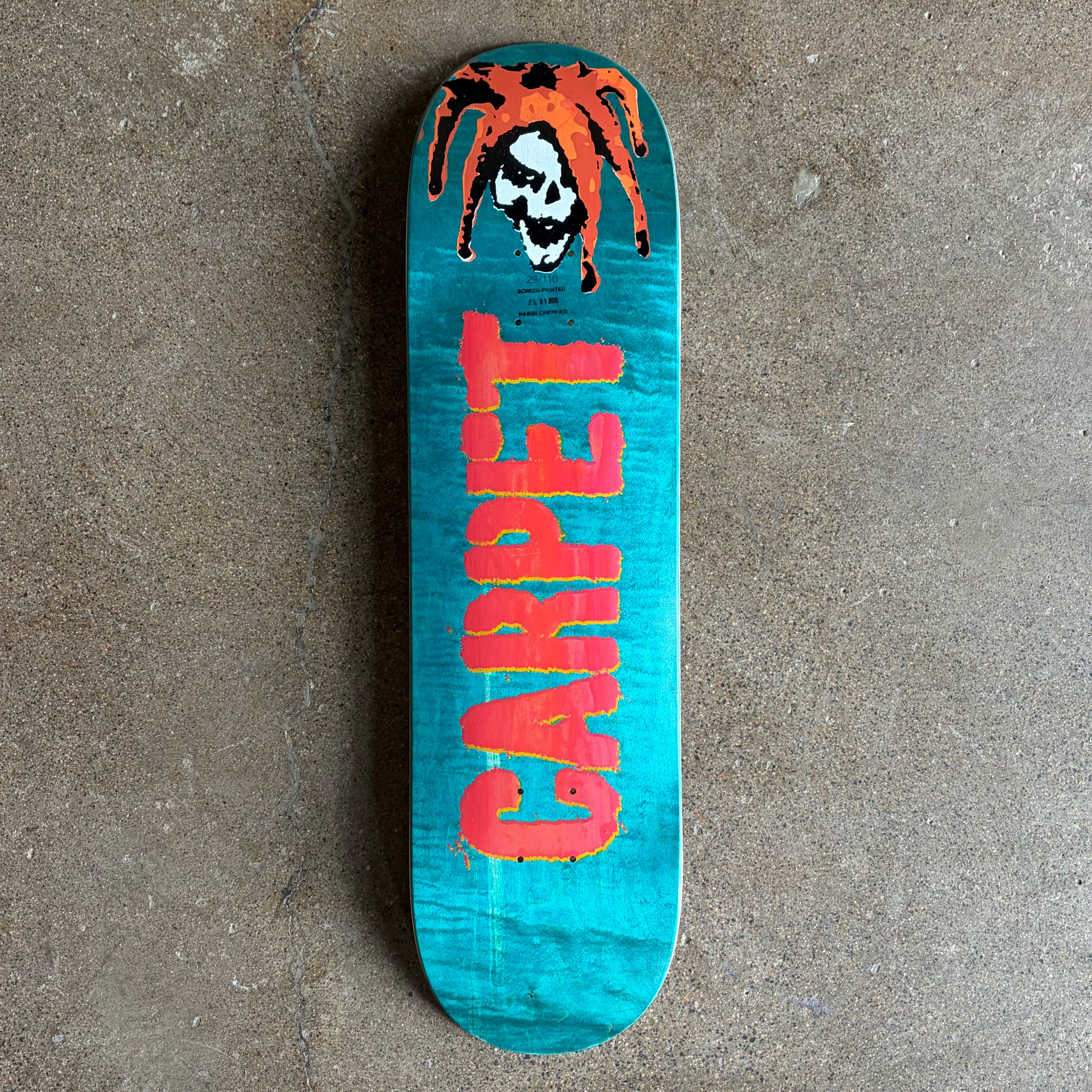 Full image of Carpet Company Jester Deck. Assorted Veneers with red carpet text across bottom and cartoon jester on nose.