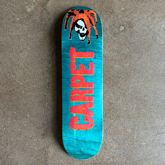 Full image of Carpet Company Jester Deck. Assorted Veneers with red carpet text across bottom and cartoon jester on nose.