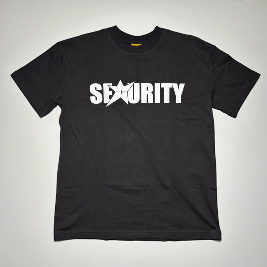 Front image of black tee with white printed art on front.