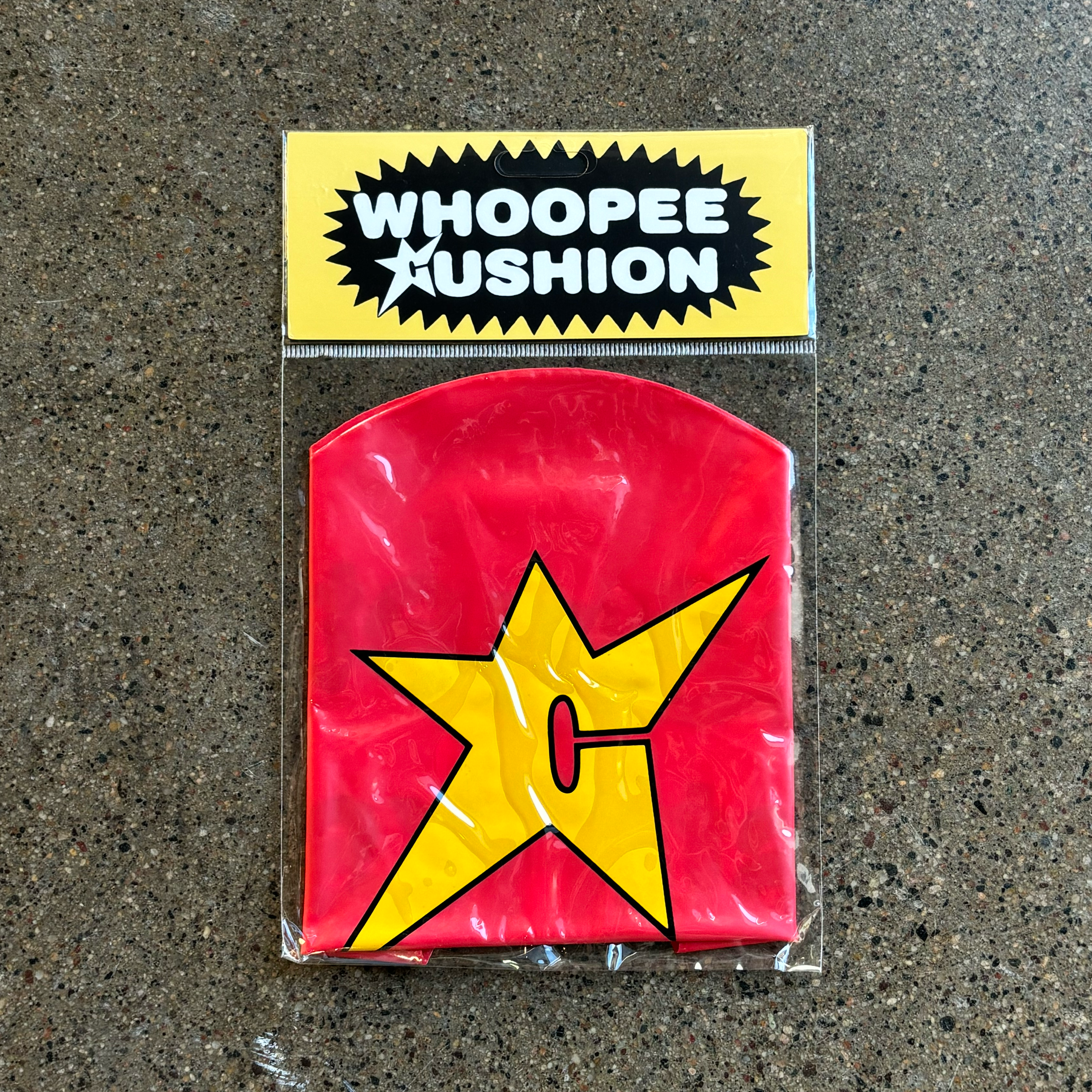 Bagged yellow c-star printed logo whoopee cushion in classic red.