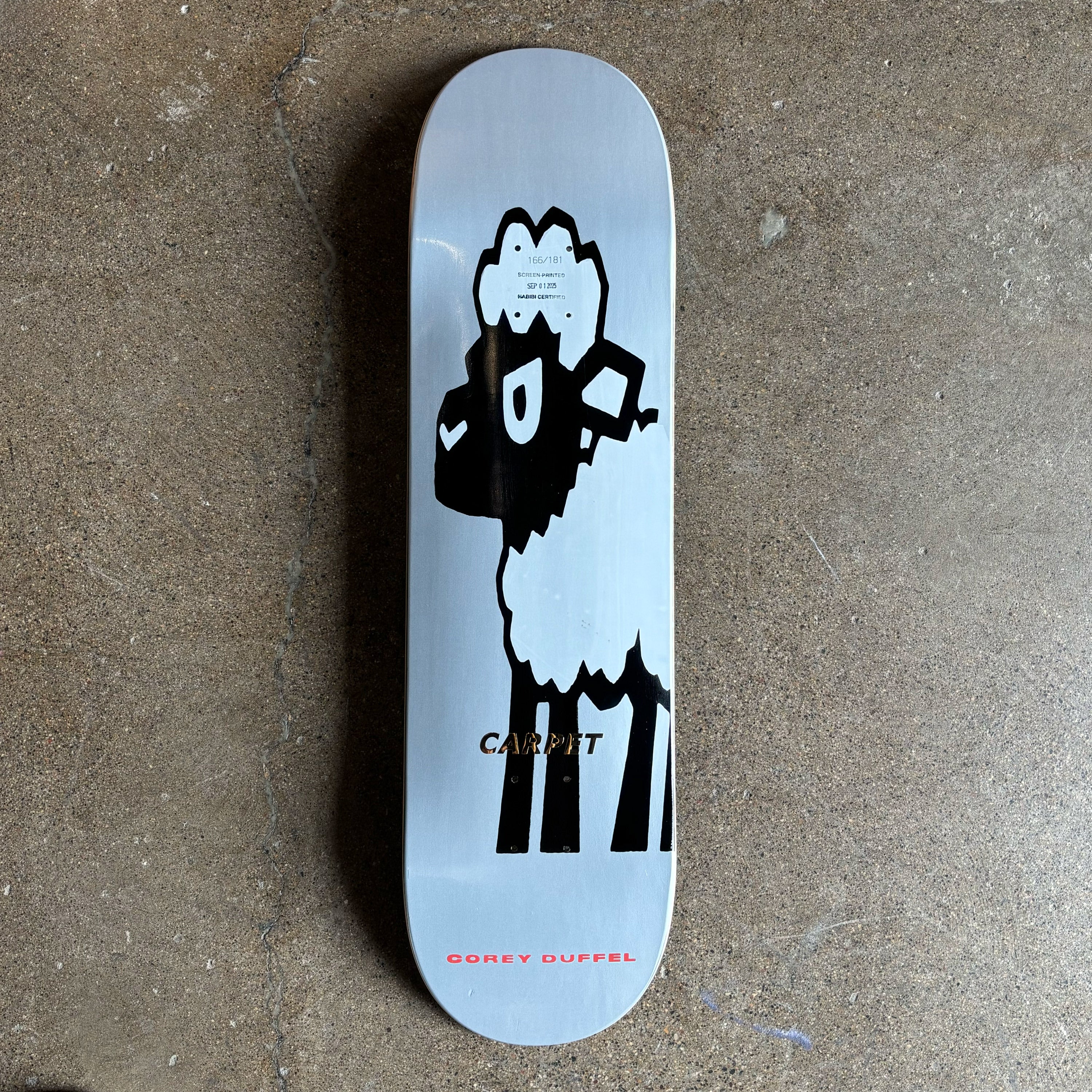 Full image of skateboard deck. Black sheep art work printed on grey background.