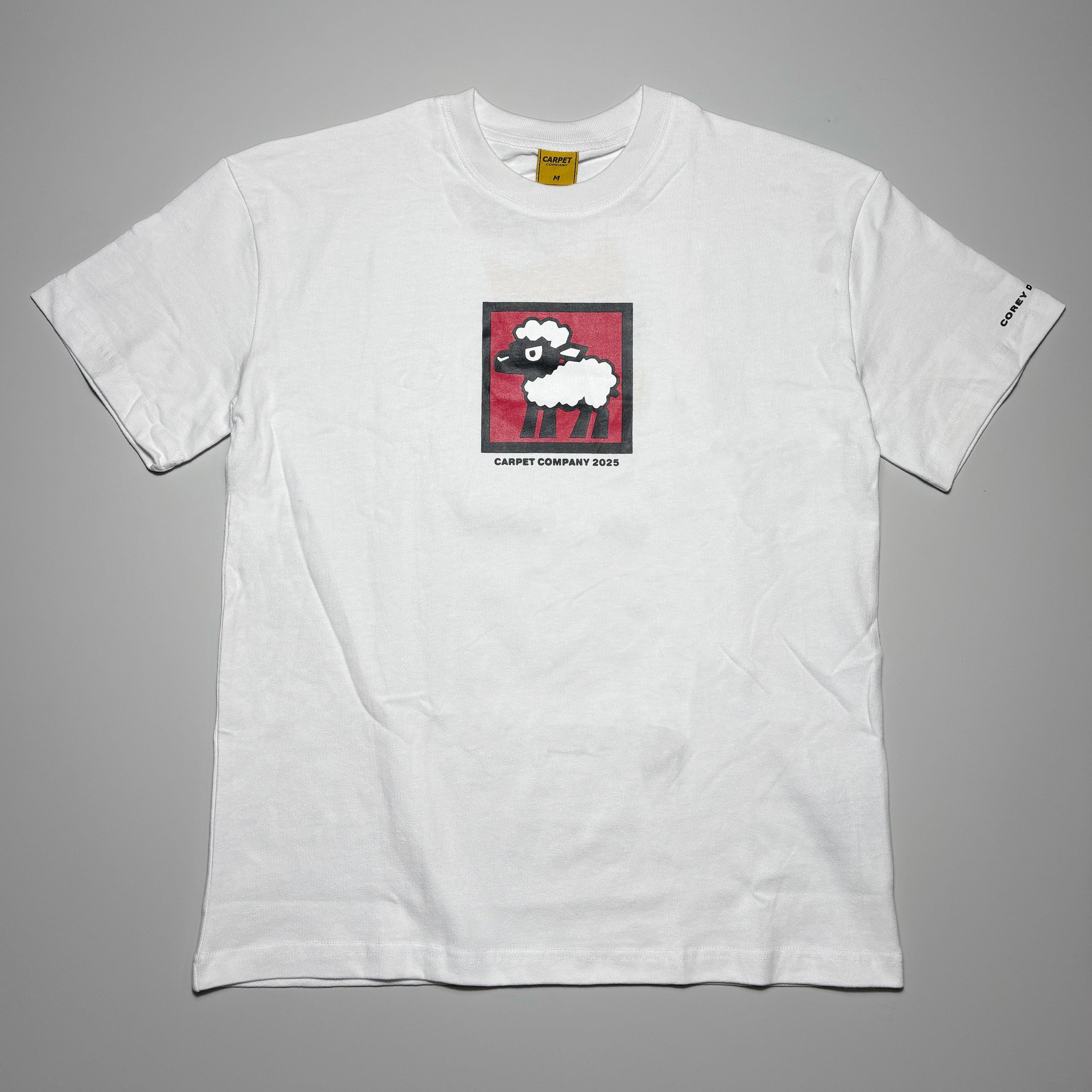 Front image of white tee with black sheep art printed on chest.