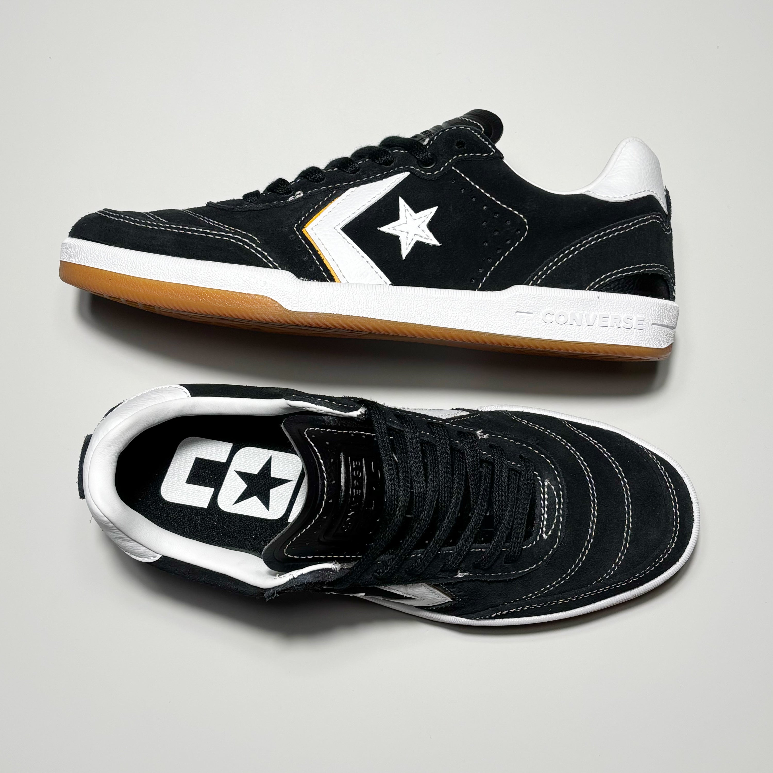 Toe down view with side profile. Contrast stitch toe and CONS embossed logo on tongue.