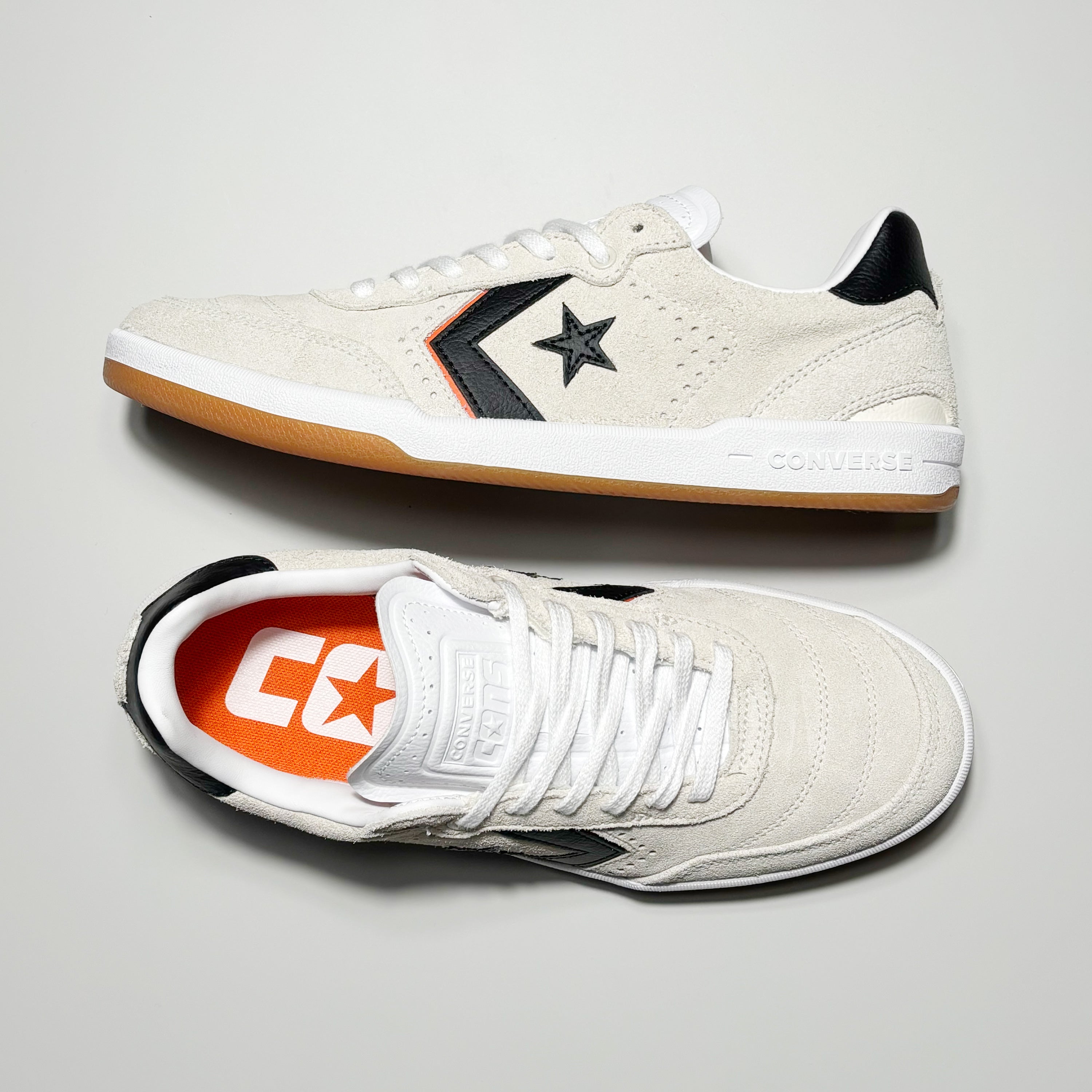 Toe down view with side profile. Contrast stitch toe and CONS embossed logo on tongue.