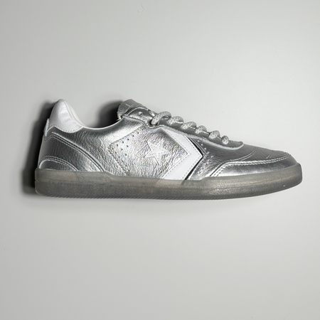 Side image of right shoe. Silver painted leather with white logo.