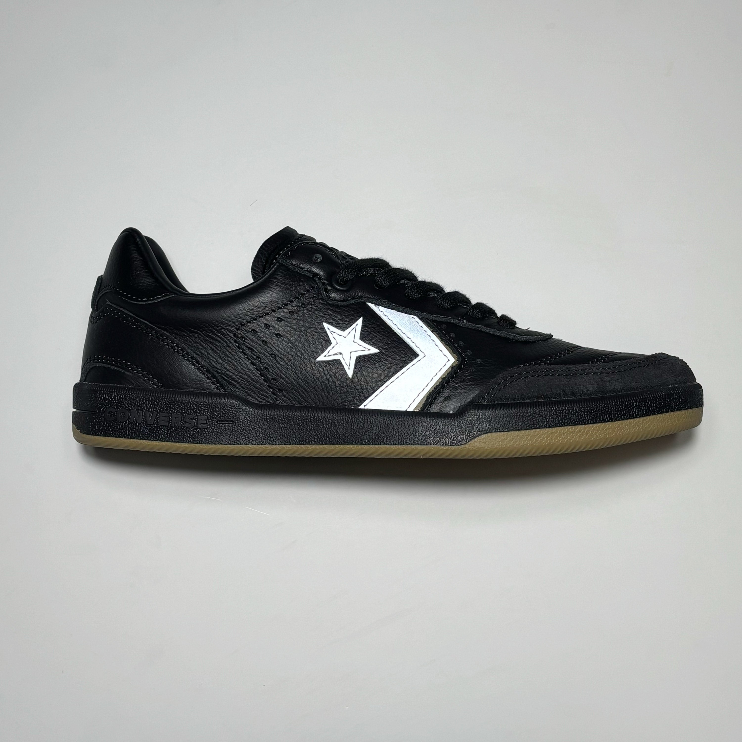 Side image of right shoe. Black suede toe and black leather mid-panels. 3M reflective branding. 