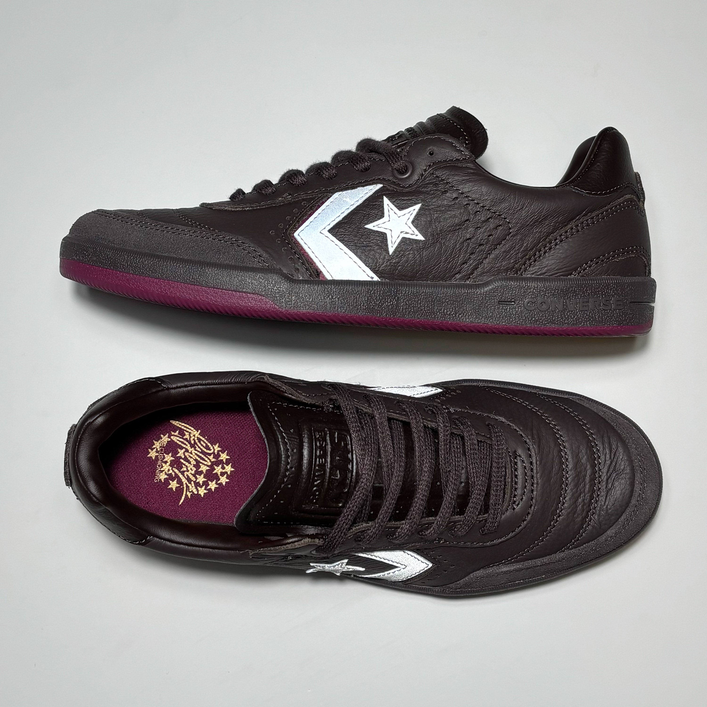 Toe down view with side profile. CONS embossed branding on tongue.