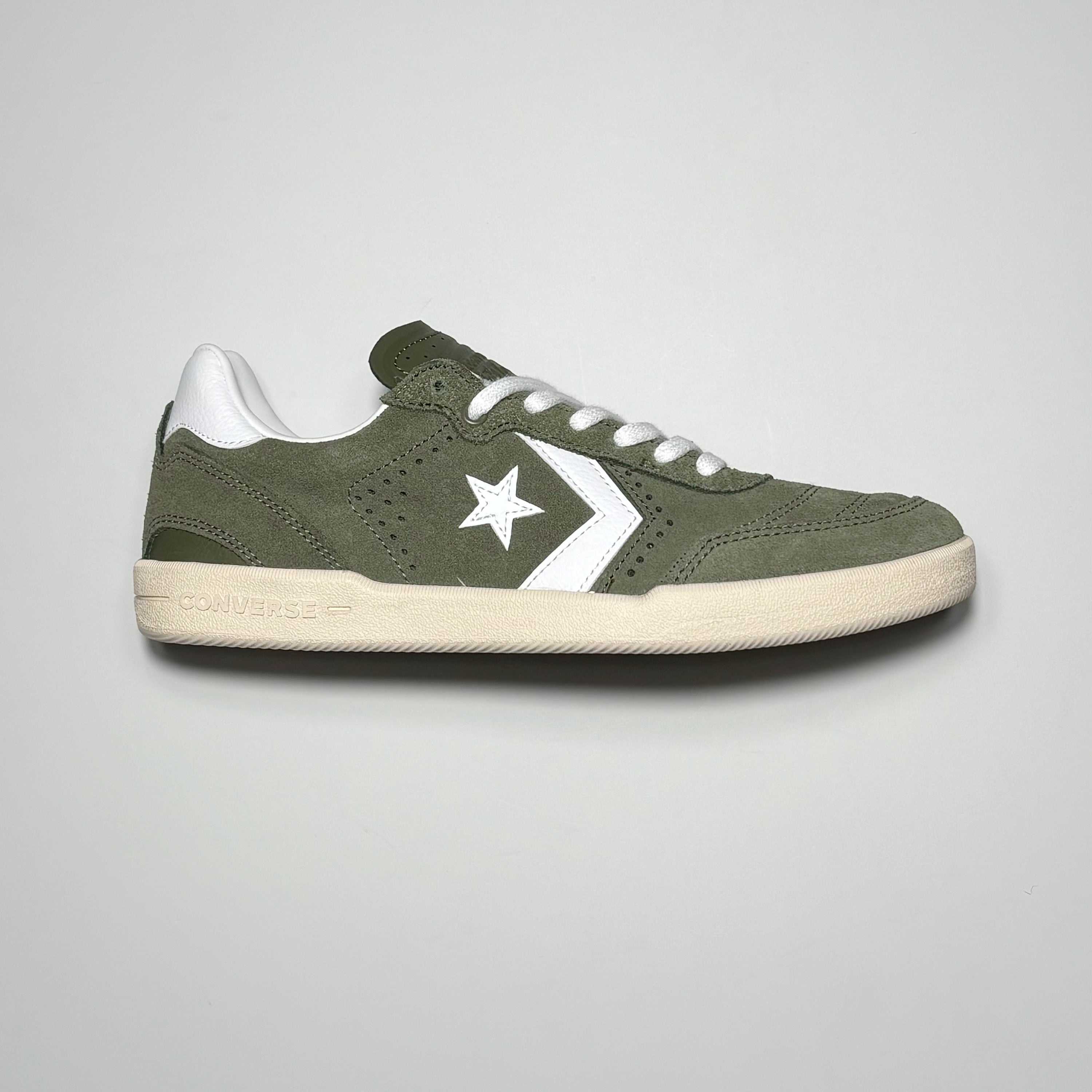 Side image of right shoe. Olive green suede with white logo on mid panel