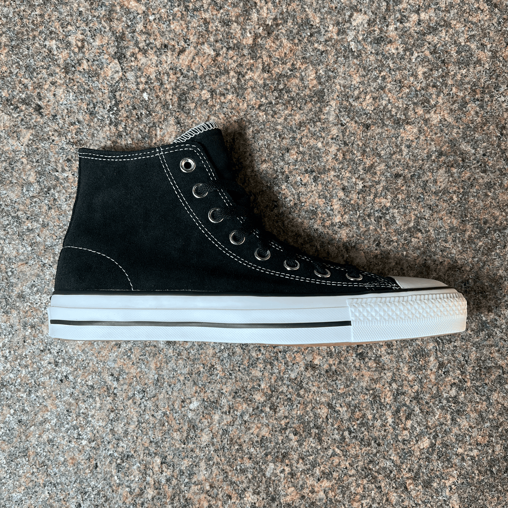 SINGLE CONVERSE CONS CTAS PRO IN BLACK SUEDE AND WHITE SOLE DISPLAYED ON GRANITE