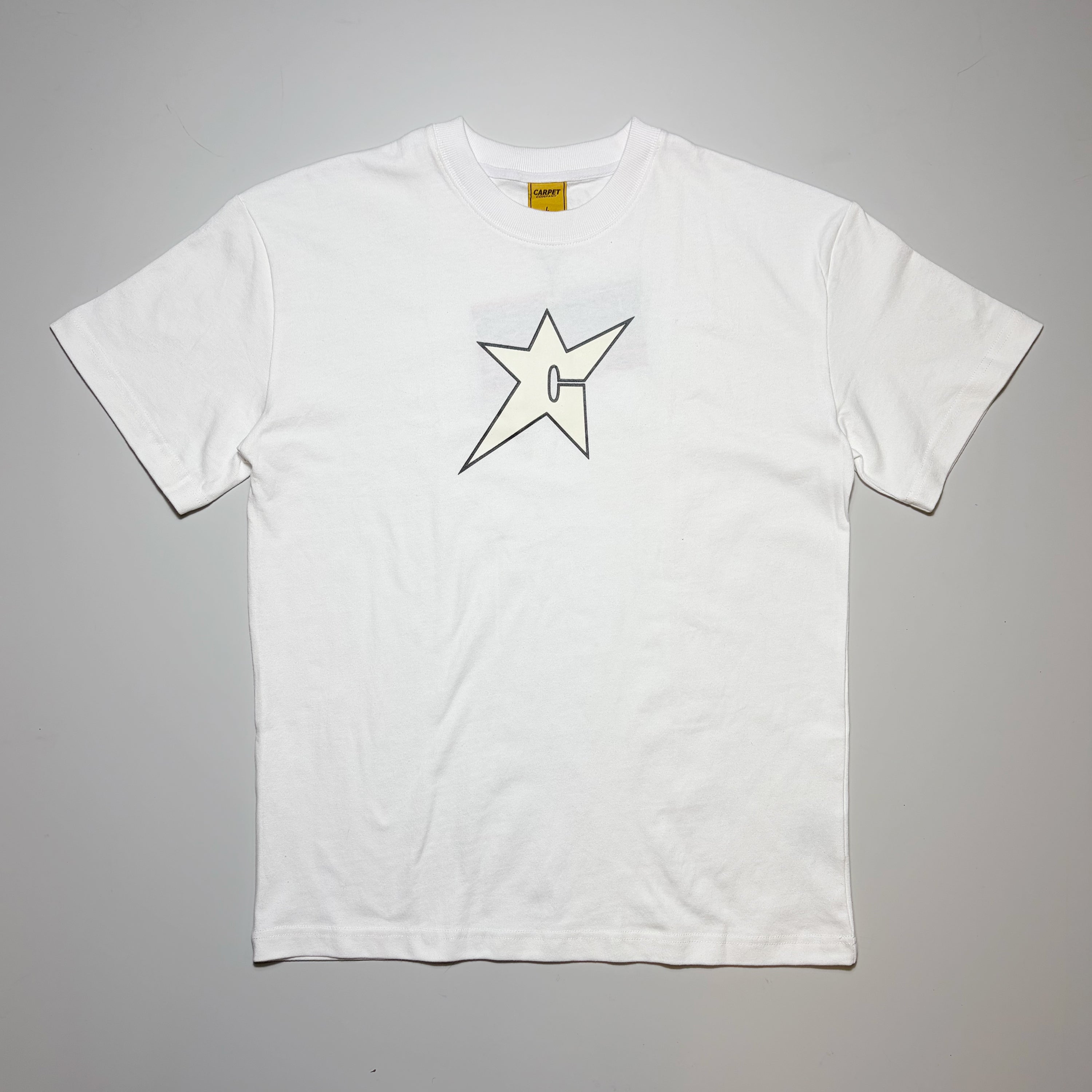 Front image of white tee with glow-in the dark c-star printed on chest. Carpet Company Season 22