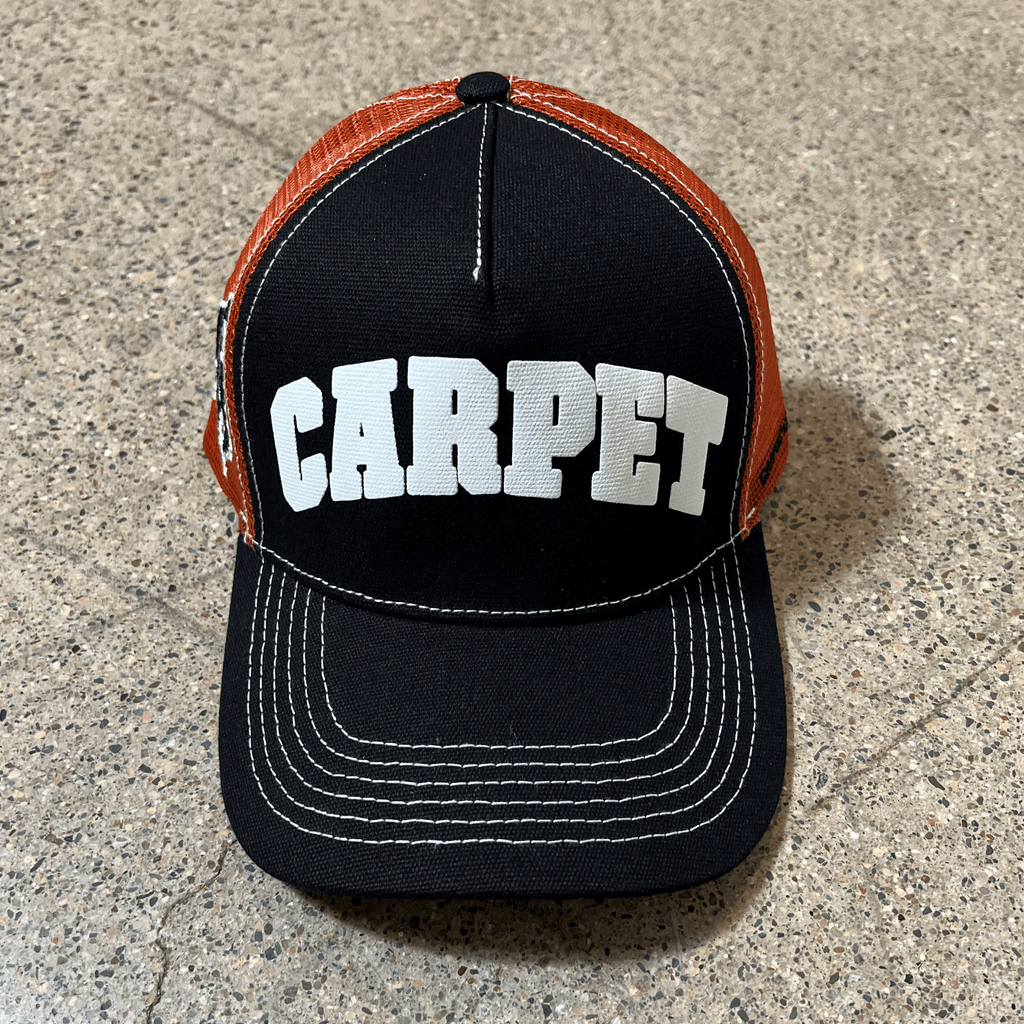 Full front image of hat.
White printed carpet font on black crown with white stitching