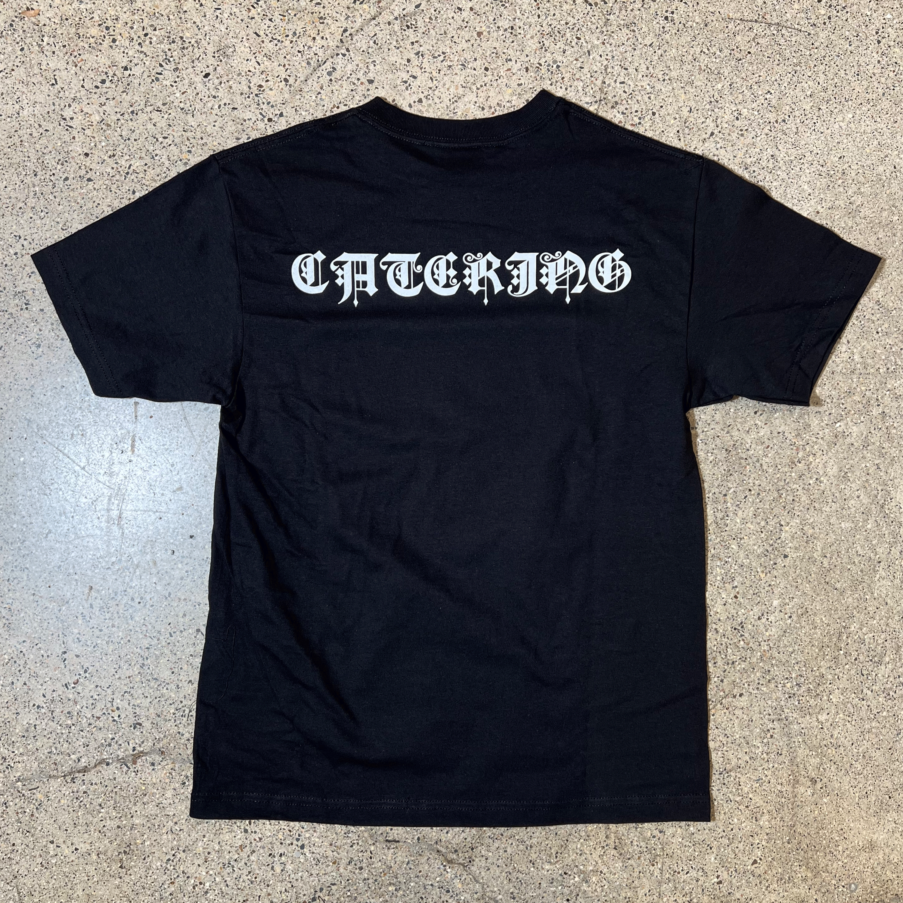 BACKSIDE OF BLACK T-SHIRT WITH OLD ENGLISH FONT 
