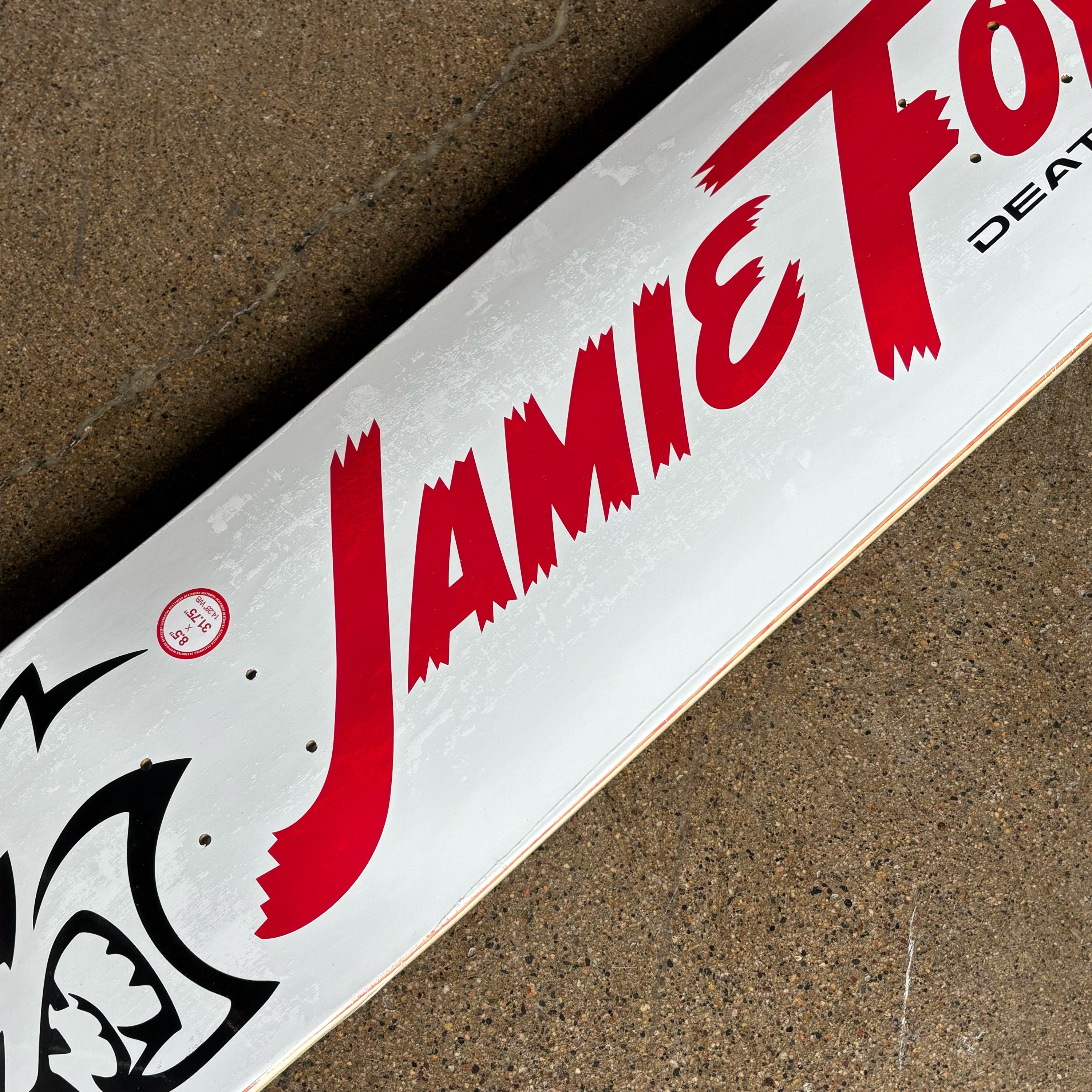 Skateboard deck with 'Jamie Foy' branding on a textured surface