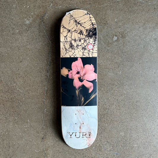 Full image of skateboard deck, 3 paneled artwork. Including a flower, spiderweb and white marble with text. 