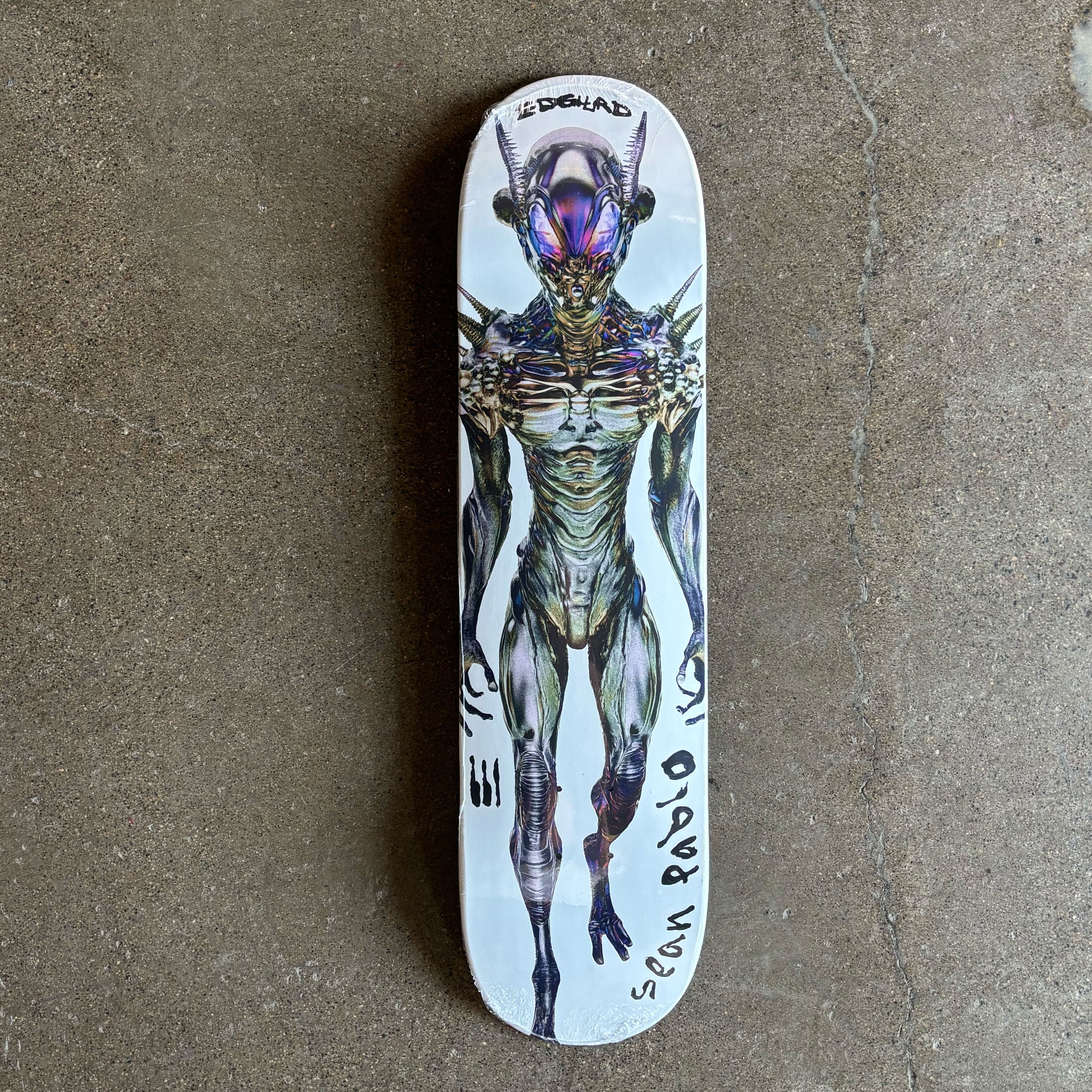 Full image of white deck with alien art from top to bottom. Sean Pablo text on tail in black.
