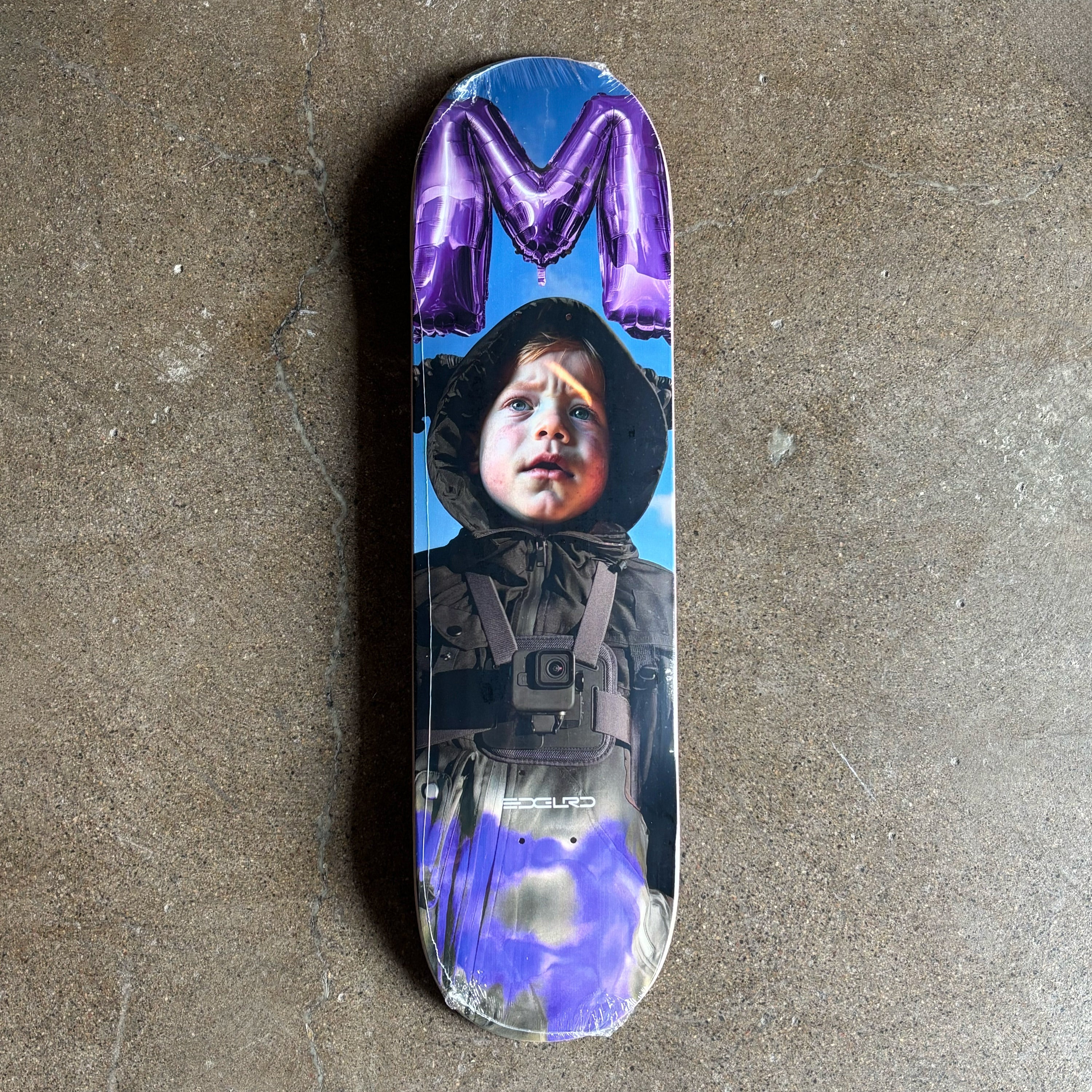 Full image of deck with a printed design of a child wearing a hooded jacket on.